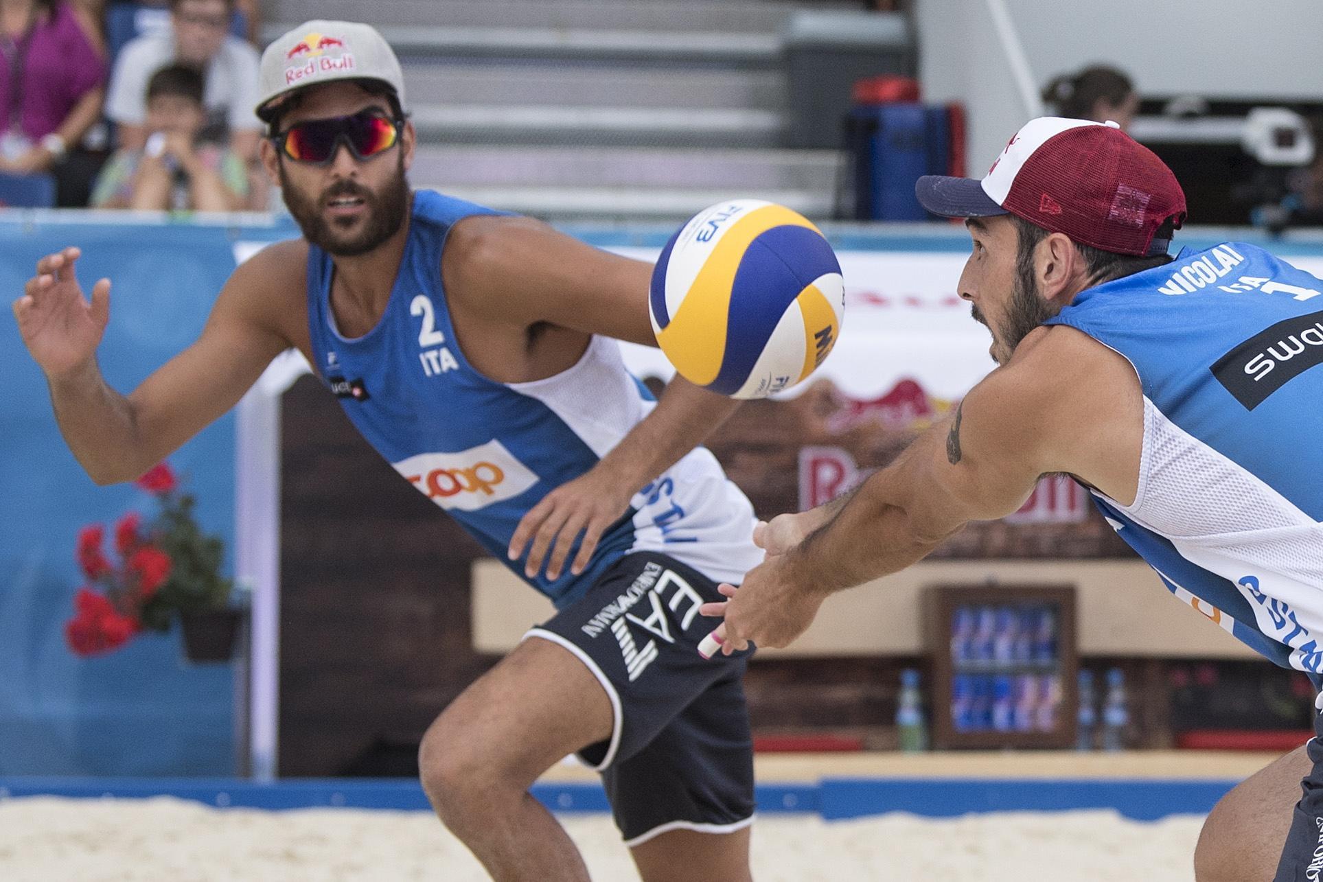 epa06888567 Daniele Lupo (L) of Italy and teammate Paolo Nicolai of Italy in action during the men's bronze medal match at the Beachvolley Worldtour Major Series event, in Gstaad, Switzerland, 14 July 2018.  EPA/PETER SCHNEIDER