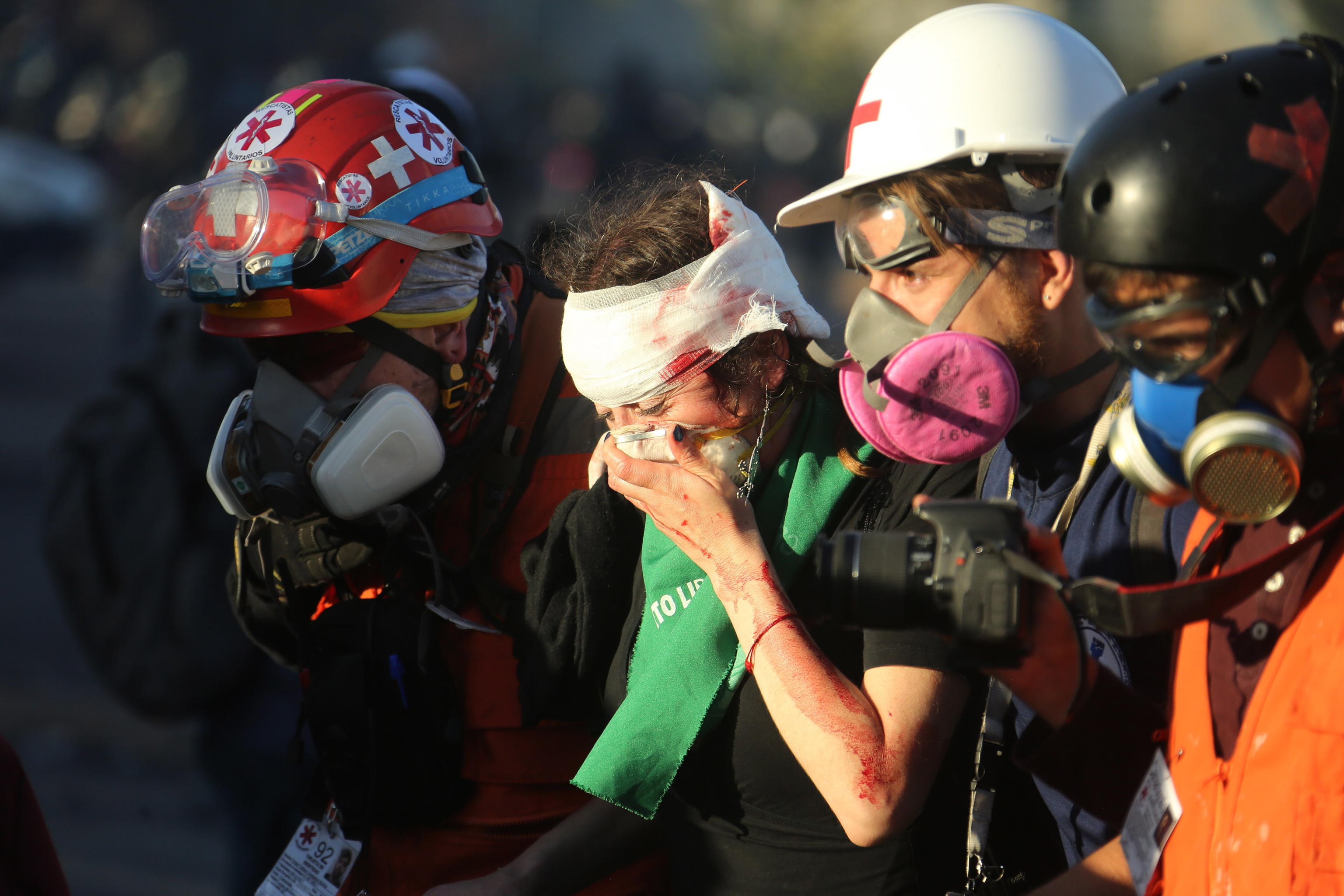 epaselect epa08084344 Demonstrators react during an anti-government protest at Plaza Italia in Santiago, Chile, 20 December 2019. Chile has been witnessing a wave of protests against social inequality since October 2019 when the government announced a price rise in metro tickets.  EPA/ELVIS GONZALEZ