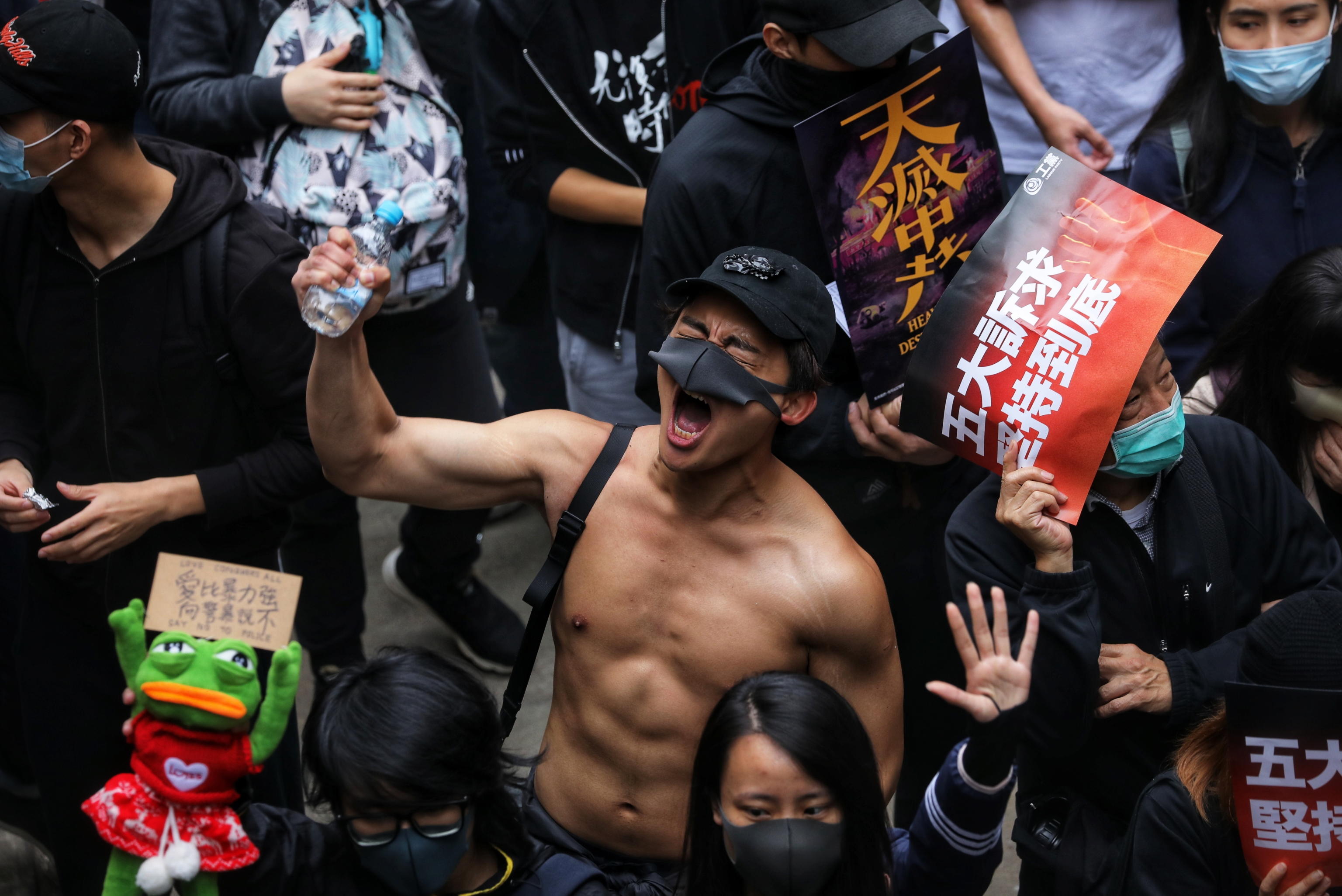 epaselect epa08097219 A protester shouts during an anti-government rally on New Year's Day in Hong Kong, China, 01 January 2020. Hong Kong has entered its seventh month of mass protests, originally triggered by a now withdrawn extradition bill, that have since turned into a wider pro-democracy movement.  EPA/VIVEK PRAKASH