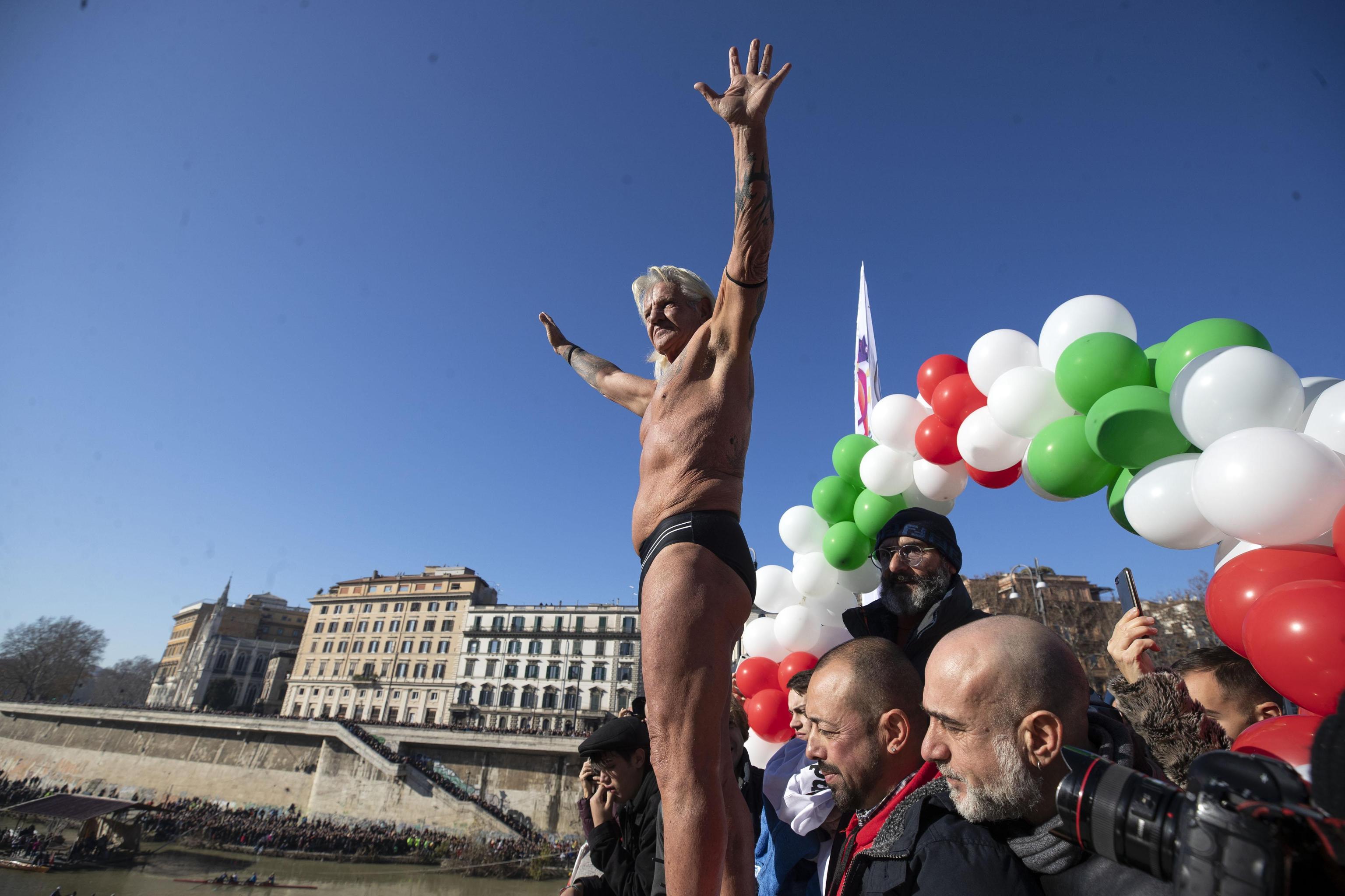 Italian Maurizio Palmulli, aka 'Mister Ok', prepares to jump from the Cavour Bridge to celebrate the arrival of the new year in Rome, Italy, 01 January 2020. During this New Year's tradition, men jump off the 15-meter-high bridge into the waters of the Tiber River.
ANSA/ MASSIMO PERCOSSI