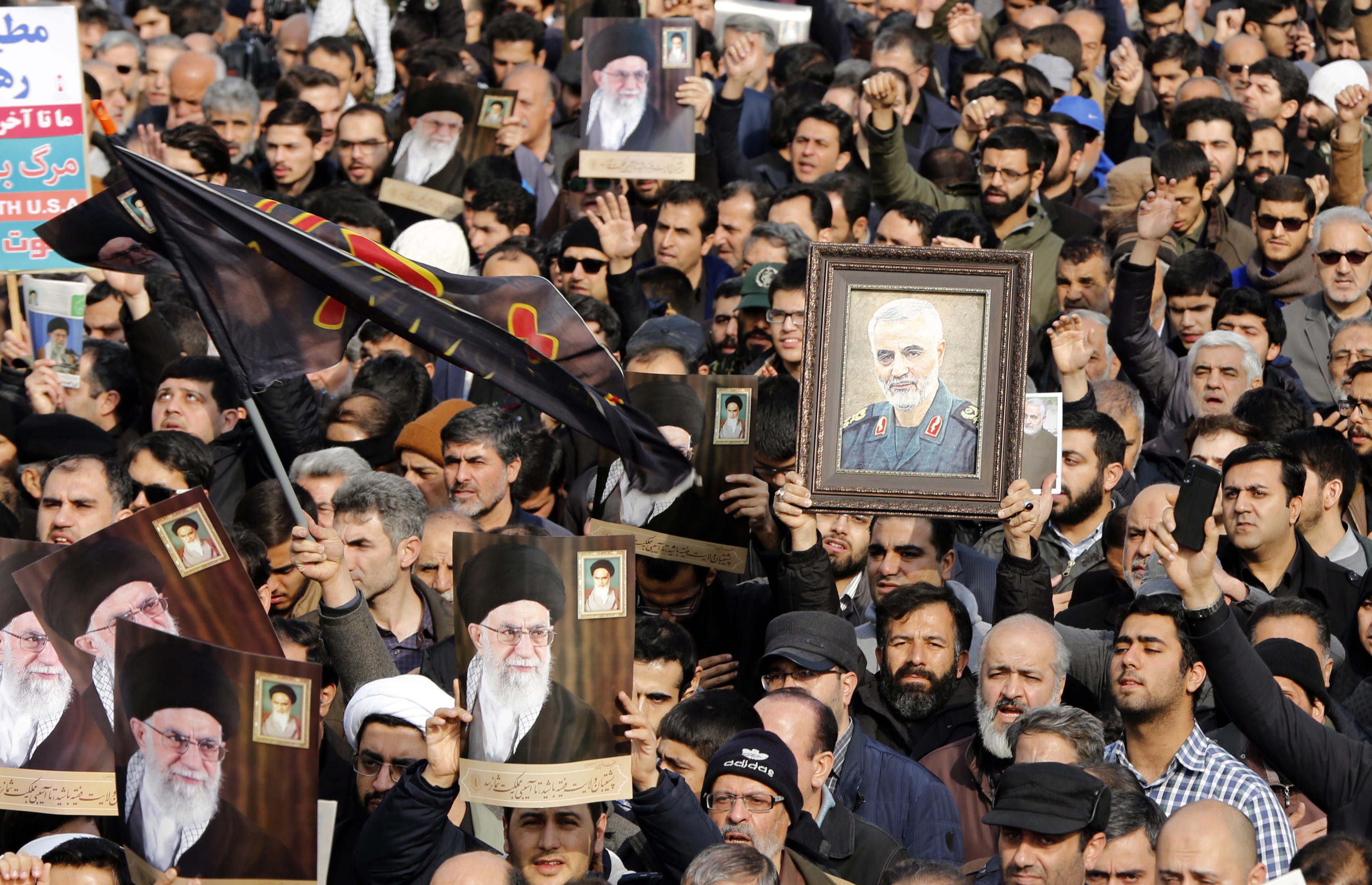 epa08099832 Iranians holding pictures of Supreme Leader Ali Khamenei and of Iranian Revolutionary Guards Corps (IRGC) Lieutenant general and commander of the Quds Force Qasem Soleimani take to the streets during an anti-US demonstration to condemn the killing of Soleimani, after Friday prayers in Tehran, Iran, 03 January 2020. The Pentagon announced that Iran's Quds Force leader Qasem Soleimani and Iraqi militia commander Abu Mahdi al-Muhandis were killed on 03 January 2020 following a US airstrike at Baghdad's international airport. The attack comes amid escalating tensions between Tehran and Washington.  EPA/ABEDIN TAHERKENAREH