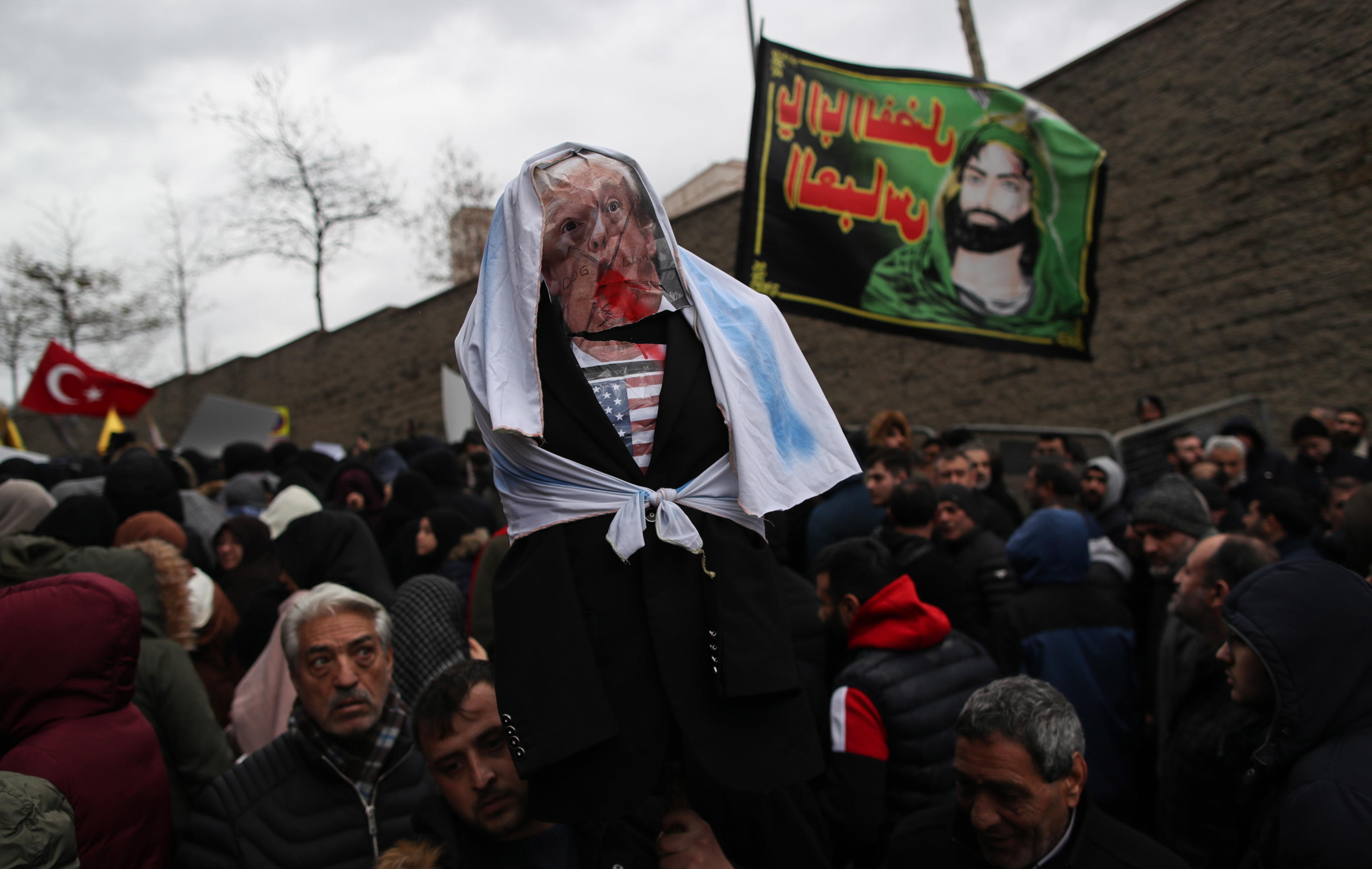 epa08104448 Protesters holds effigy of US President Donald Trump during a demonstration in front of the US consulate in Istanbul, Turkey, 05 January 2020. Iran's Quds Force leader Qasem Soleimani and Iraqi militia commander Abu Mahdi al-Muhandis were killed on 03 January 2020 following a US airstrike at Baghdad's international airport. The attack comes amid escalating tensions between Tehran and Washington  EPA/ERDEM SAHIN