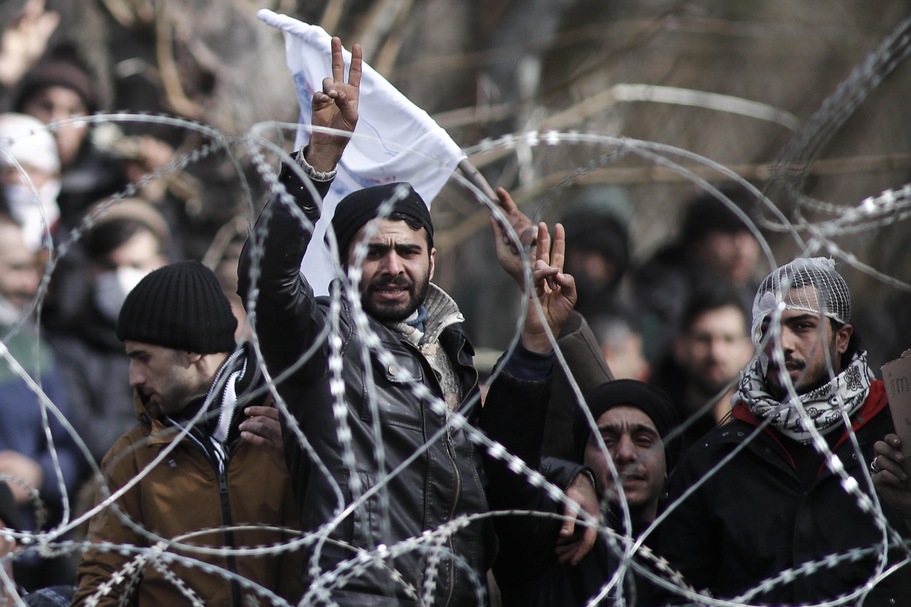 epa08264367 Refugees and migrants gather on the Turkish side of the closed Kastanies border crossing, on the borderline between Greece and Turkey, near the Evros River, in an attempt to cross into Greece, 02 March 2020. Thousands of refugees and migrants are gathering on the Turkish side of the border with Greece with the intent to cross into the European Union following the Turkish government's decision to loosen controls on migrant flows after the death of 33 Turkish soldiers killed in an attack in Idlib, Syria on 27 February.  EPA/DIMITRIS TOSIDIS