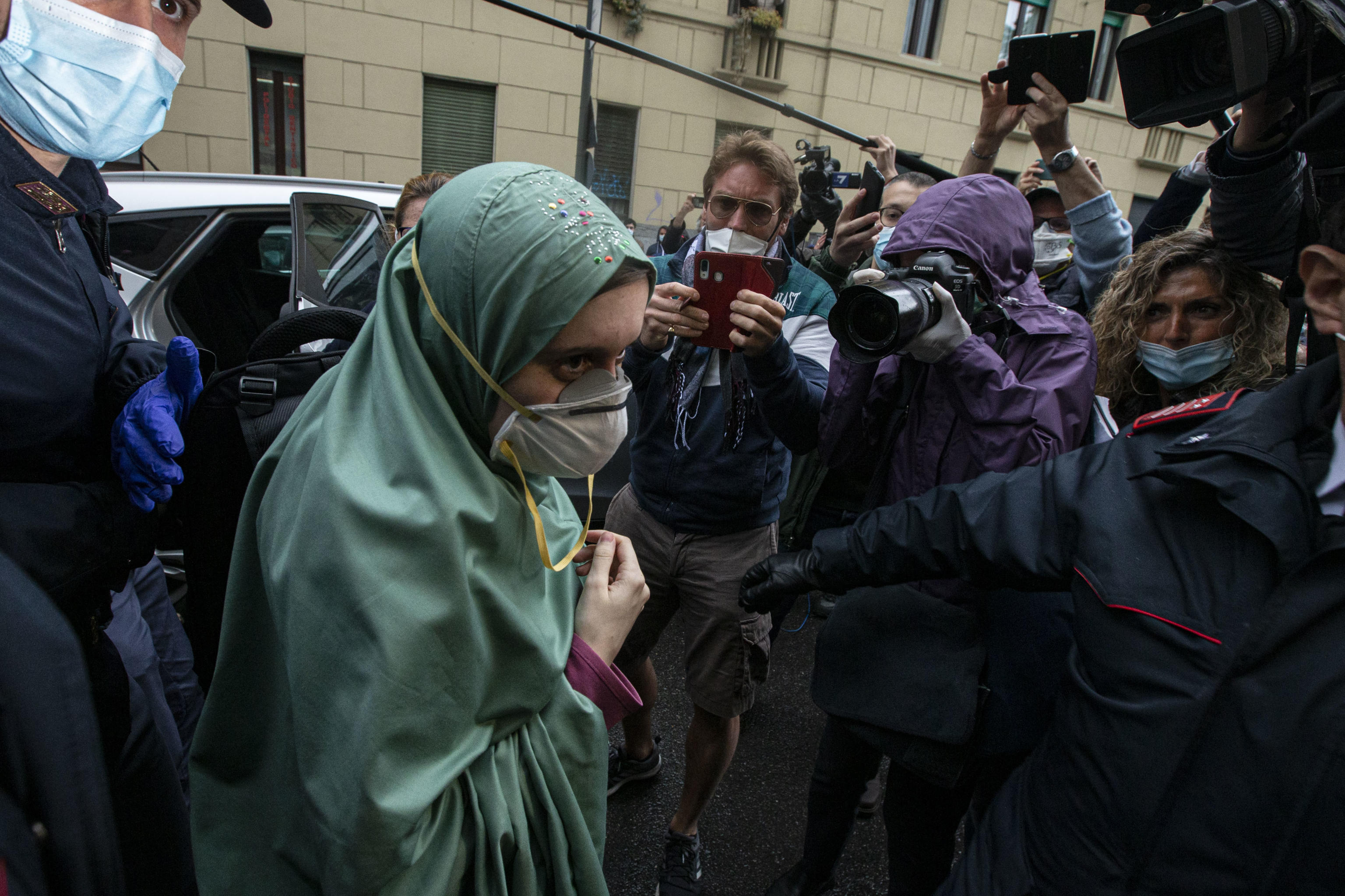 Silvia Romano, arrives at her home wearing a protective mask, Milan, Italy, 11 May  2020. The young Italian woman has returned to her homeland after 18 months as a hostage in eastern Africa.ANSA/Marco Ottico