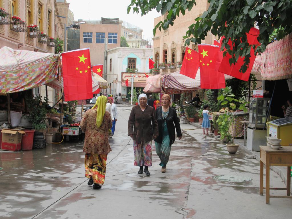 To counter secessionist sentiments, the Chinese government requires that Chinese flags hang from every building along Areya Road in the old town of Kashgar, Xinjiang, China.