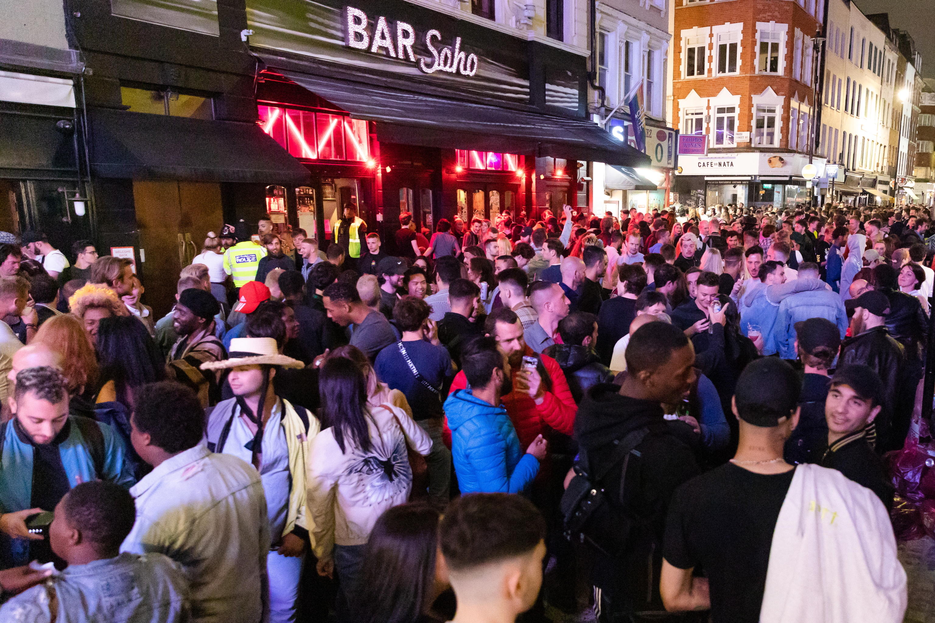 epa08528369 Revellers drink and socialize in the street during the evening in Soho, London, Britain, 04 July 2020 (issued 05 July 2020). Pubs, restaurants, places of worship, hairdressers and other businesses have reopened their doors across the UK on 'Super Saturday' after more than three months of lockdown due to the coronavirus pandemic.  EPA/VICKIE FLORES