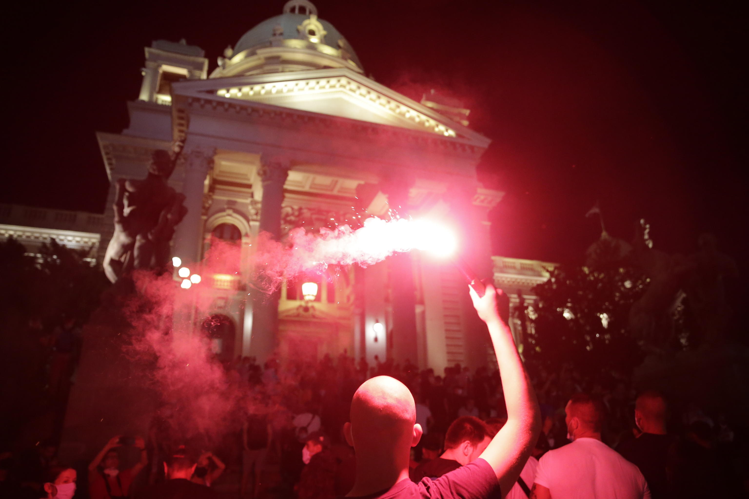 epa08539468 A protestor lights up a flare during the protest against the strict measures to fight the coronavirus in Belgrade, Serbia, 10 July 2020. Thousands have gathered in front of the Serbian Parliament in Belgrade to protest the new measures to stem the spread of the SARS-CoV-2 coronavirus, which causes the COVID-19 disease.  EPA/ANDREJ CUKIC