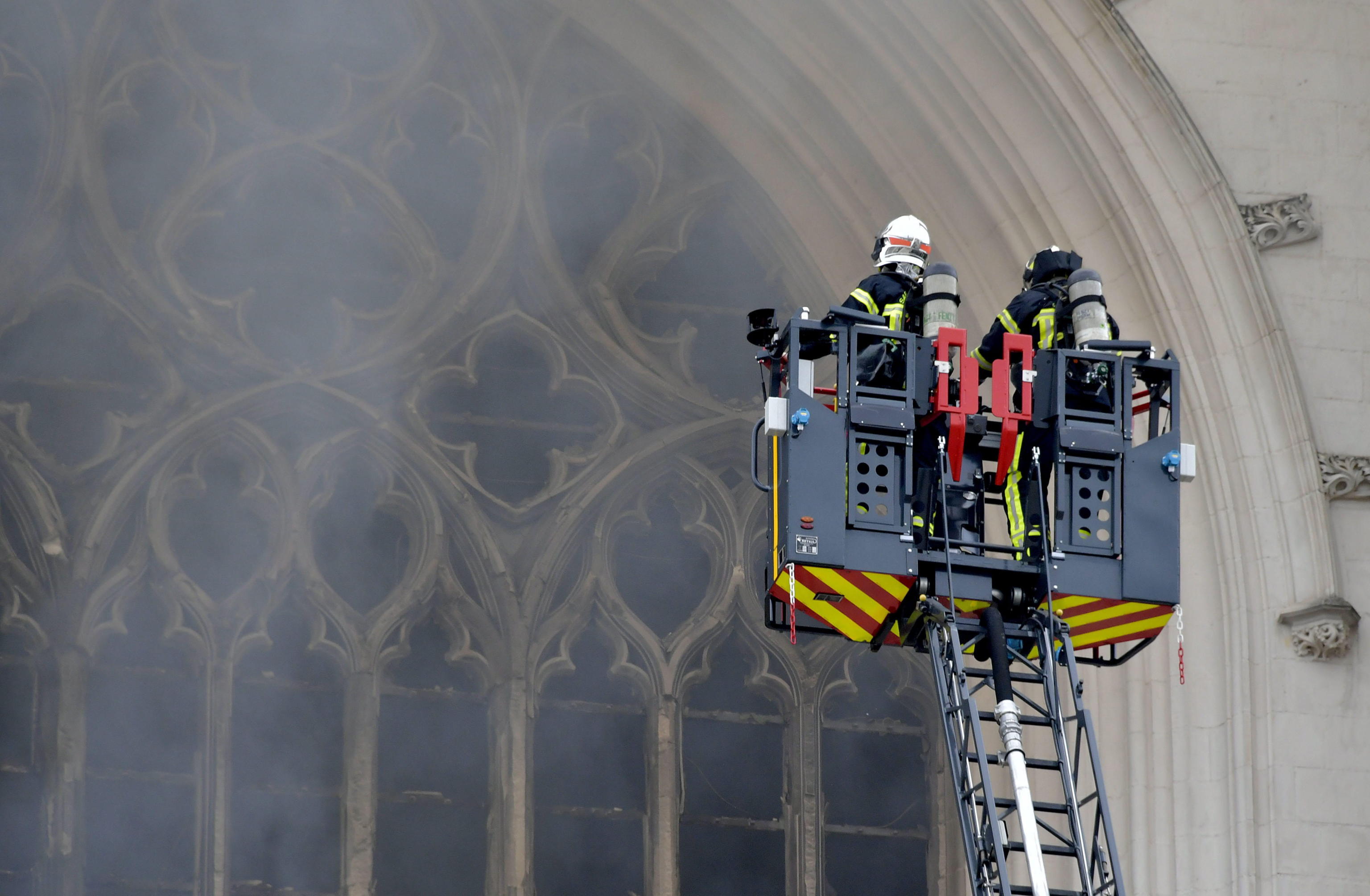epa08553436 Fire fighters brigade work to extinguish the blaze at the Saint Peter and Saint Paul Cathedral, in Nantes, France, 18 July 2020. The blaze that broke inside the gothic cathedral of Nantes 18 has been contained, emergency officials said.   FRANCE OUT / SHUTTERSTOCK OUT