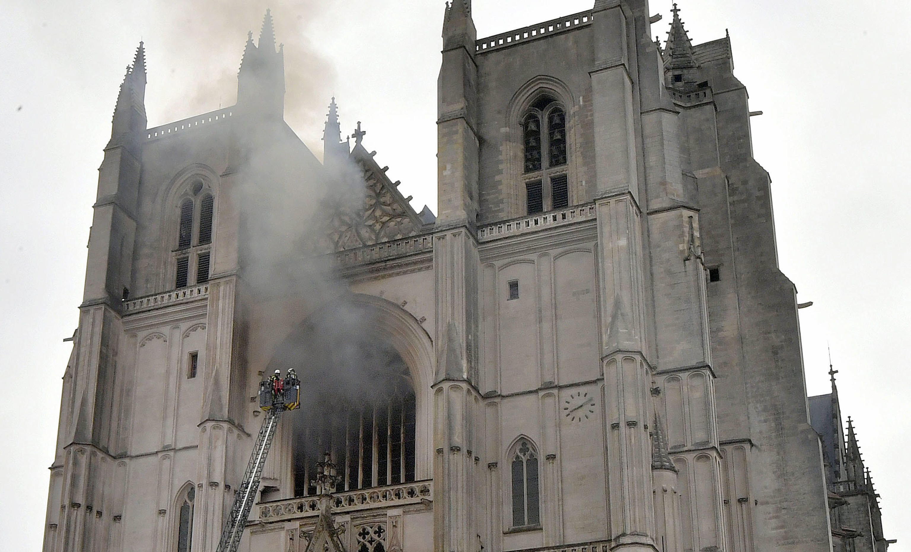epa08553435 Fire fighters brigade work to extinguish the blaze at the Saint Peter and Saint Paul Cathedral, in Nantes, France, 18 July 2020. The blaze that broke inside the gothic cathedral of Nantes 18 has been contained, emergency officials said.   FRANCE OUT / SHUTTERSTOCK OUT