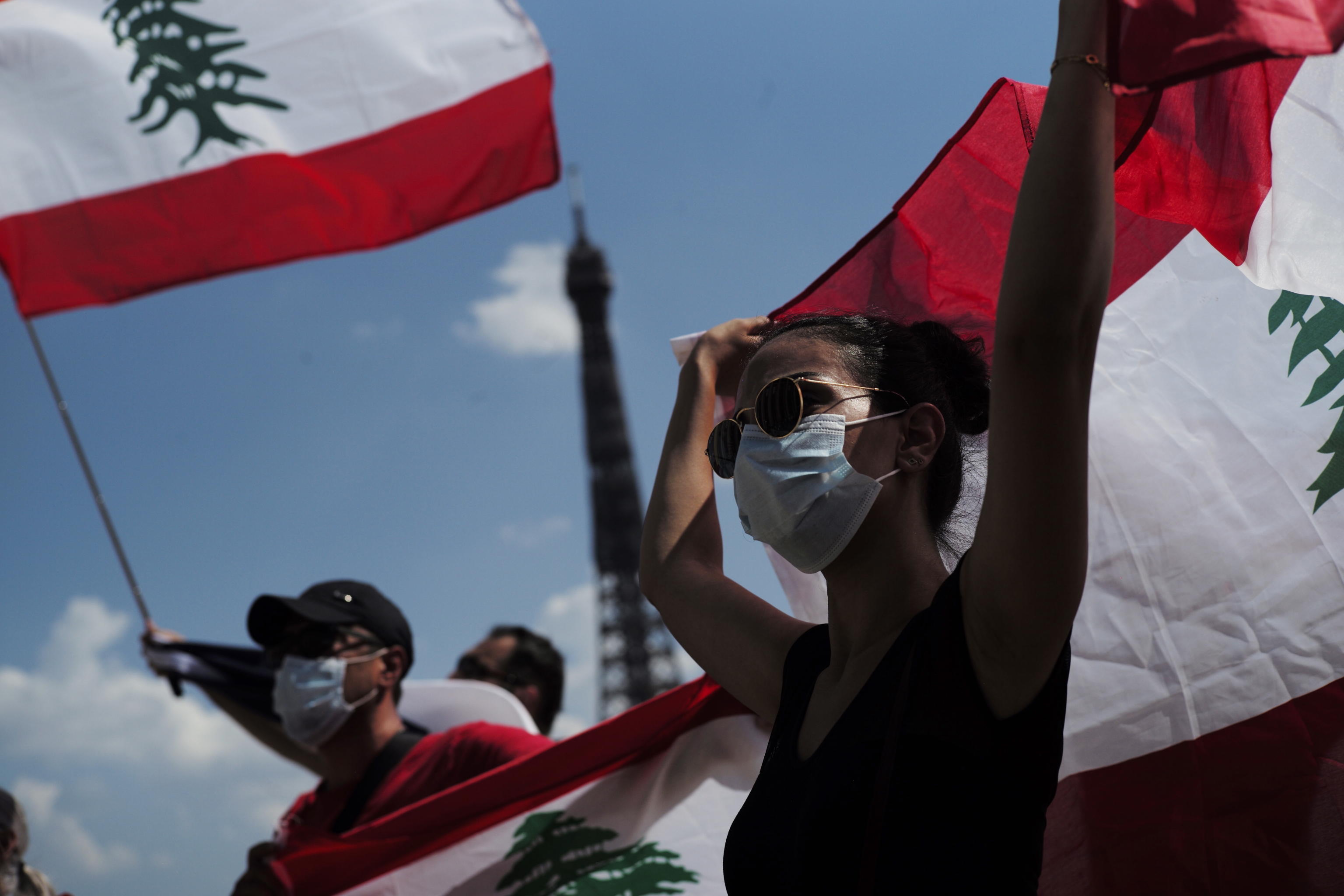 epa08593894 Peoples gather during a demonstration to show solidarity with Beirut people after a night of violent protest against Lebanese government, at Trocadero square in Paris, France, 09 August 2020. The Lebanese Health Ministry on 07 August said at least 154 people were killed, and more than 5,000 injured in the Beirut blast that devastated the port area on 04 August and believed to have been caused by an estimated 2,750 tons of ammonium nitrate stored in a warehouse.  EPA/Julien de Rosa
