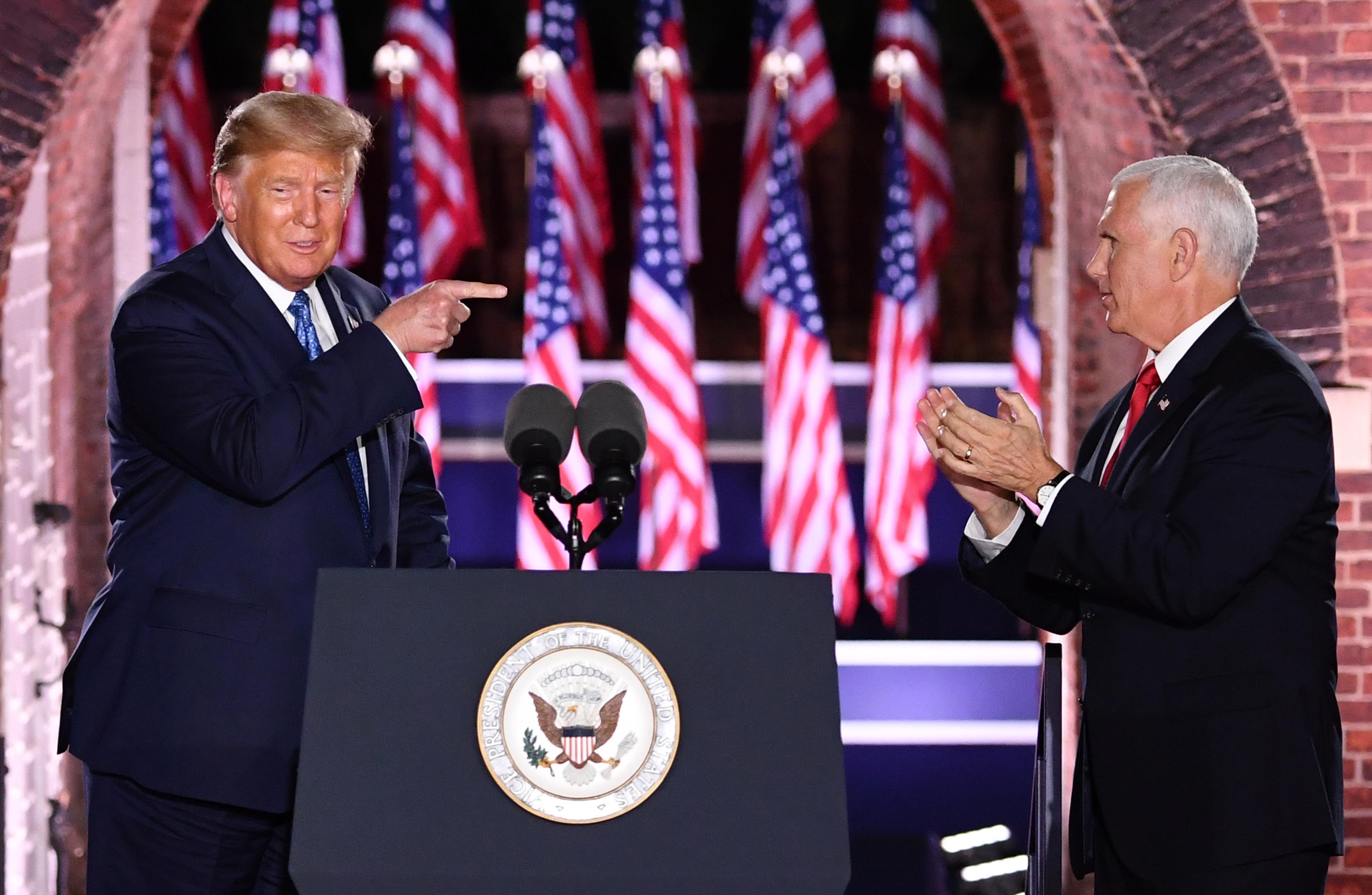 epa08628151 US President Donald J. Trump (L) joins US Vice President Mike Pence (R) on stage on the third night of the Republican National Convention, at Fort McHenry in Baltimore, Maryland, USA, 26 August 2020.  EPA/KEVIN DIETSCH / POOL
