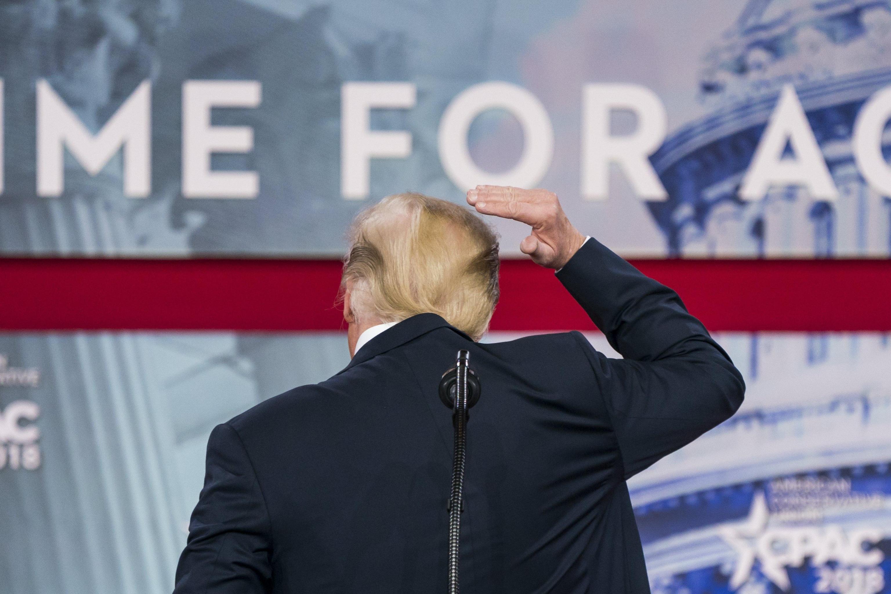 epa06558388 US President Donald J. Trump pretends to fix his hair as he addresses the 45th annual Conservative Political Action Conference (CPAC) at the Gaylord National Resort &amp; Convention Center in National Harbor, Maryland, USA, 23 February 2018. The President used the opportunity to announce new sanctions against North Korea.  EPA/JIM LO SCALZO