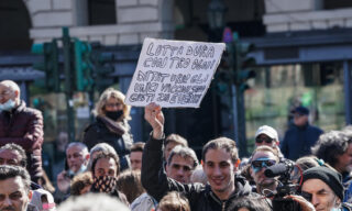 A moment of the no-masks and Covid-19 negationists manifestation in Castello square, Turin, Italy, 20 March 2021.  ANSA/TINO ROMANO