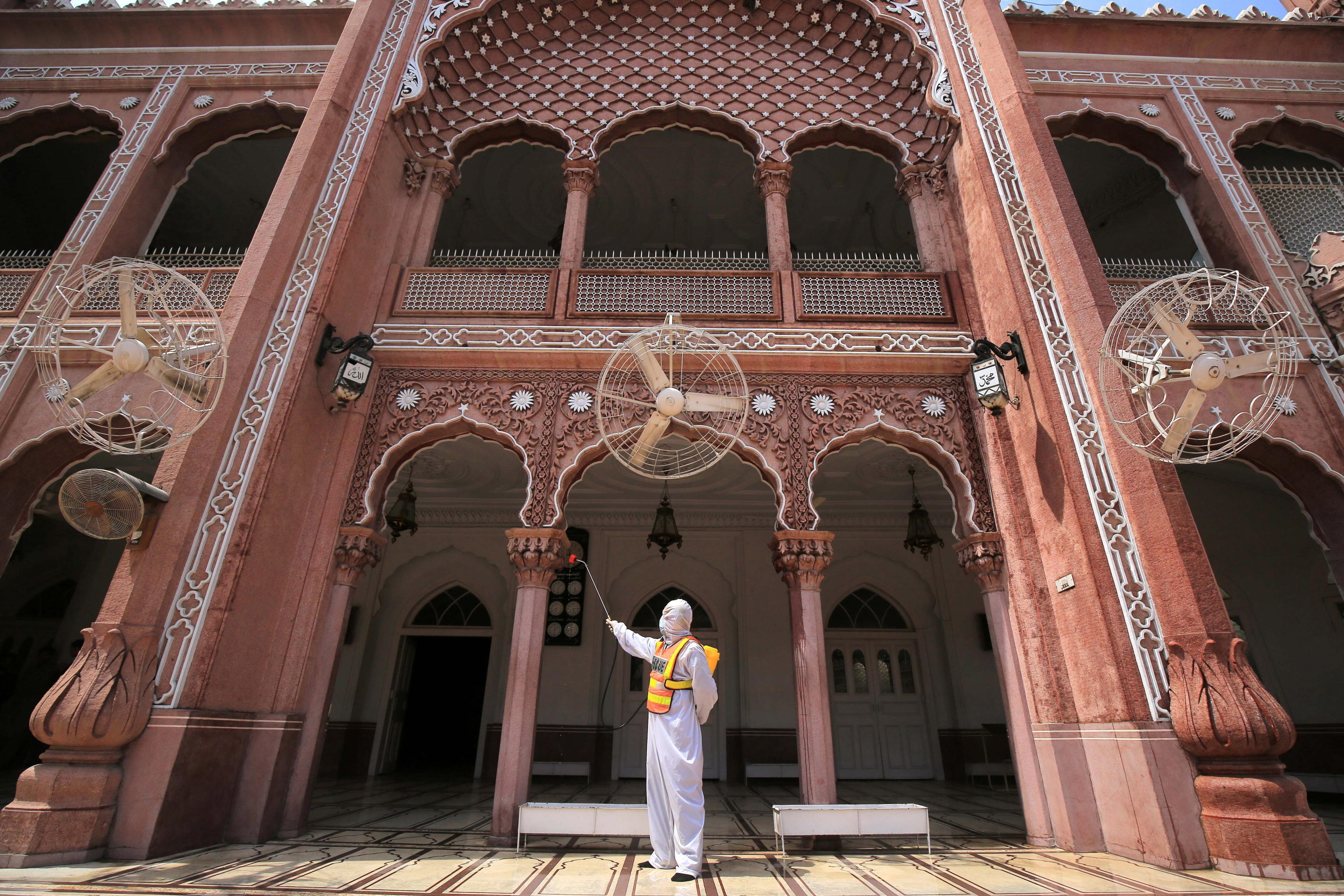 epaselect epa09132607 A rescue worker sprays disinfectant at a Mosque ahead of the holy month of Ramadan during coronavirus pandemic in Peshawar, Pakistan, 13 April 2021. Muslims began observing the dawn-to-dusk fast for the holy month of Ramadan across many parts of the Middle East on 13 April. To draw worshippers closer to God through sacrifice, remembrance and heightened spirituality.  EPA/ARSHAD ARBAB
