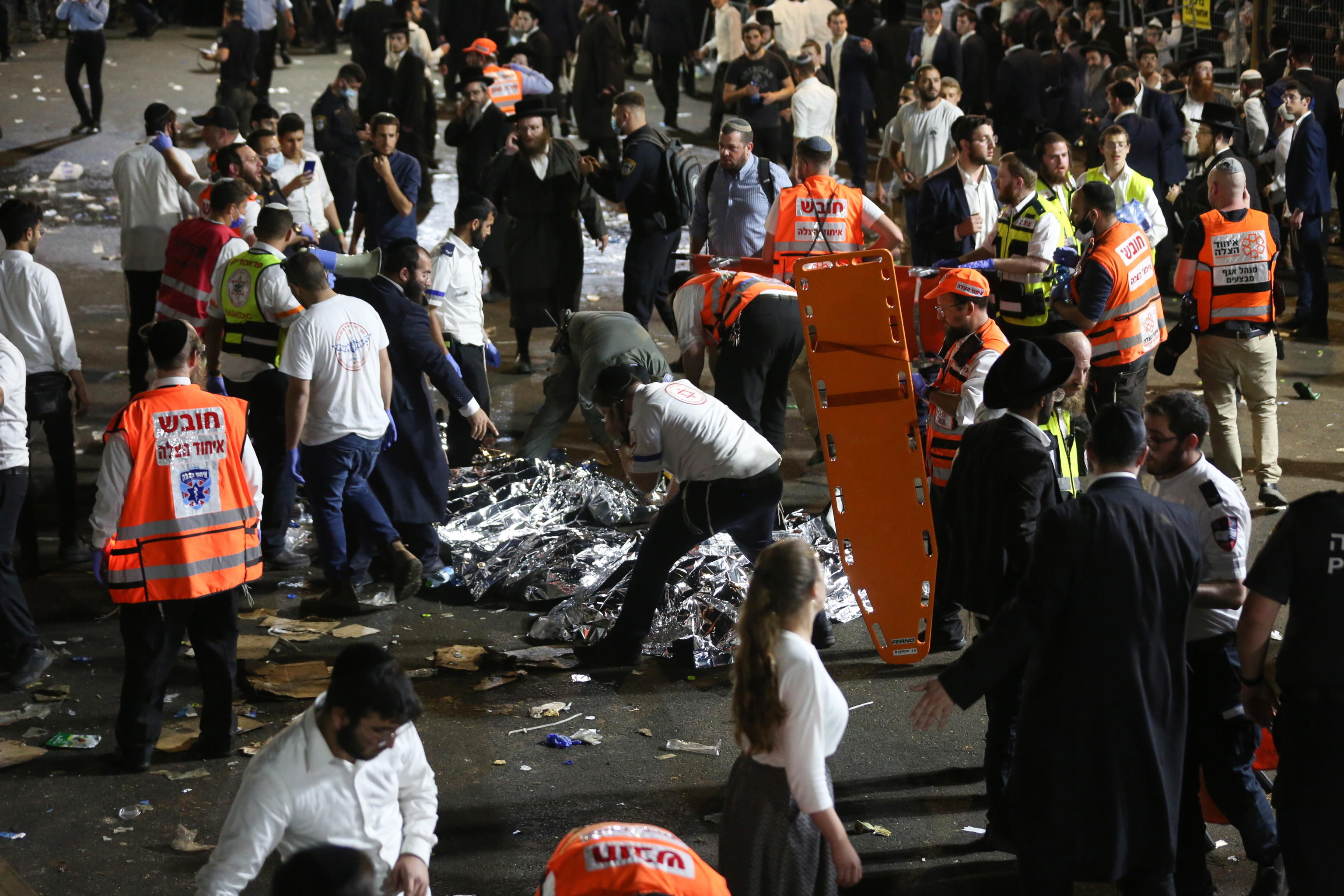 epa09168832 Israeli security officials and rescuers inspect the dead bodies of dozens of Ultra-Orthodox Jews who died during an event at a revelry complex during Lag Ba'Omer; in Mount Meron, Israel, 29 April 2021. Dozens of people were killed and injured in the revelry complex on Mount Meron, after an apparent stampede occured during an event marking the end of the Jewish holiday of Lag Ba'Omer, the day marks the anniversary of the death of Rabbi Shimon bar Yochai, a sage from some 1,800 years ago, and the day on which he revealed the secrets of the 'kabbalah,' or Jewish mysticism.  EPA/DAVID COHEN ISRAEL OUT