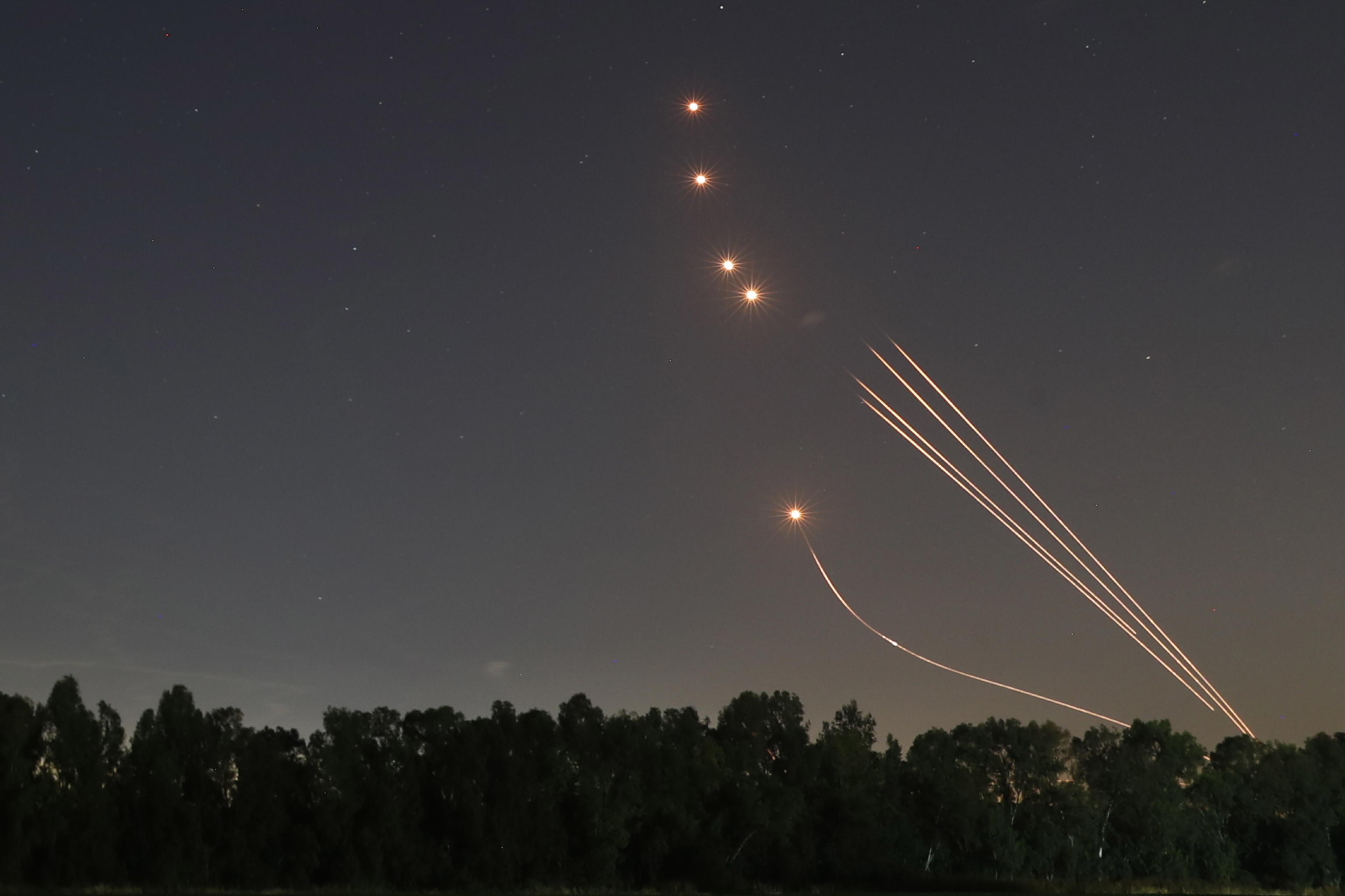 epa09198095 The trail of a rocket fired by the Israeli 'Iron Dome' anti-rocket defense system is seen in the air as it intercepts rockets fired from Gaza Strip, near the city of Sderot, Israel, 13 May 2021. Clashes erupted over the forced eviction of six Palestinian families from their homes in Sheikh Jarrah neighborhood in favor of Jewish families who claimed they used to live in the houses before fleeing in the 1948 war that led to the creation of Israel. In response to days of violent confrontations between Israeli security forces and Palestinians in Jerusalem, various Palestinian militants factions in Gaza launched rocket attacks since 10 May that killed at least six Israelis to date. The Gaza Strip's health ministry said that at least 65 Palestinians, including 13 children, were killed in the recent retaliatory Israeli airstrikes. Hamas confirmed the death of Bassem Issa, its Gaza City commander, during an airstrike.  EPA/ATEF SAFADI
