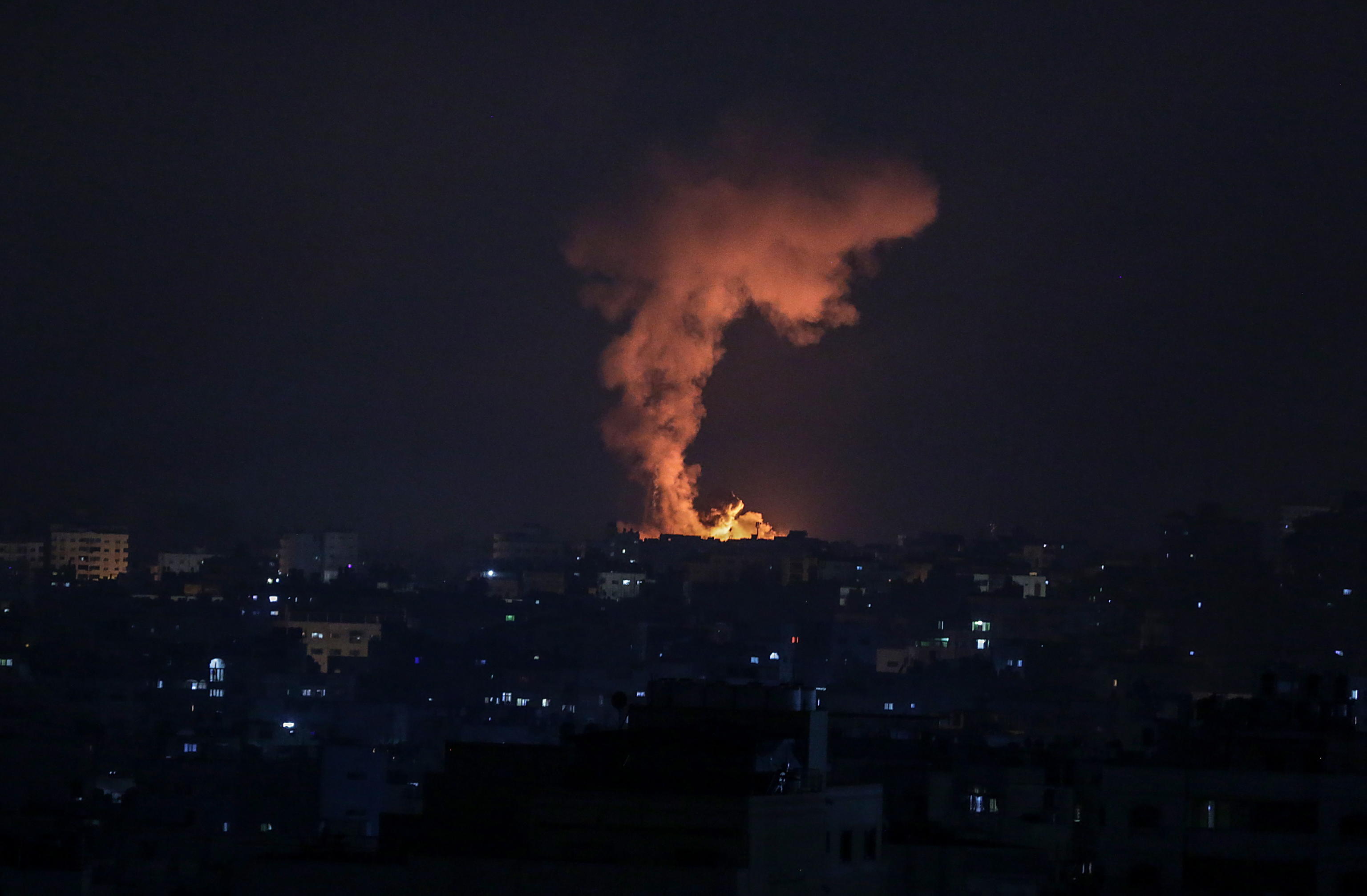 epa09198435 Smoke and flames rise after an Israeli airstrike in the northern Gaza strip, 14 May 2021. In response to days of violent confrontations between Israeli security forces and Palestinians in Jerusalem, various Palestinian militants factions in Gaza launched rocket attacks since 10 May that killed at least seven Israelis to date. Gaza Strip's health ministry said that at least 100 Palestinians, including 13 children, were killed in the recent retaliatory Israeli airstrikes. Hamas confirmed the death of Bassem Issa, its Gaza City commander, during an airstrike.  EPA/HAITHAM IMAD