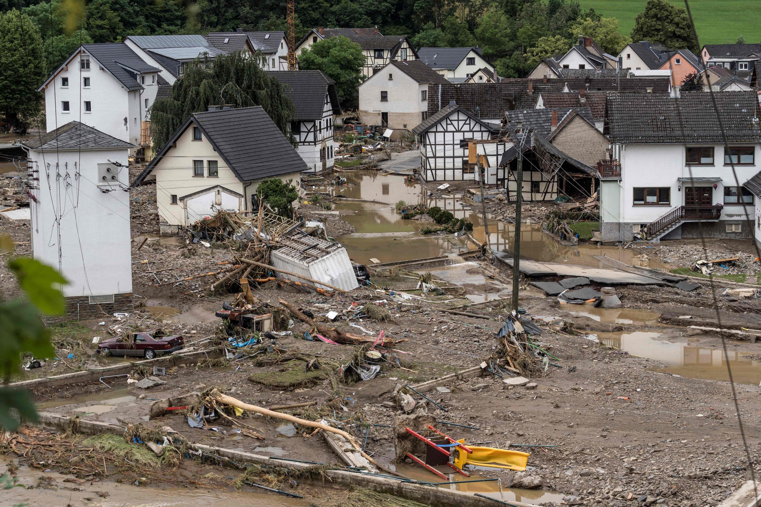 A general view shows houses within a flooded area in Schuld near Bad Neuenahr, western Germany, on July 15, 2021. - Heavy rains and floods lashing western Europe have killed at least 42 people in Germany and left many more missing, as rising waters led several houses to collapse. (Photo by Bernd LAUTER / AFP)