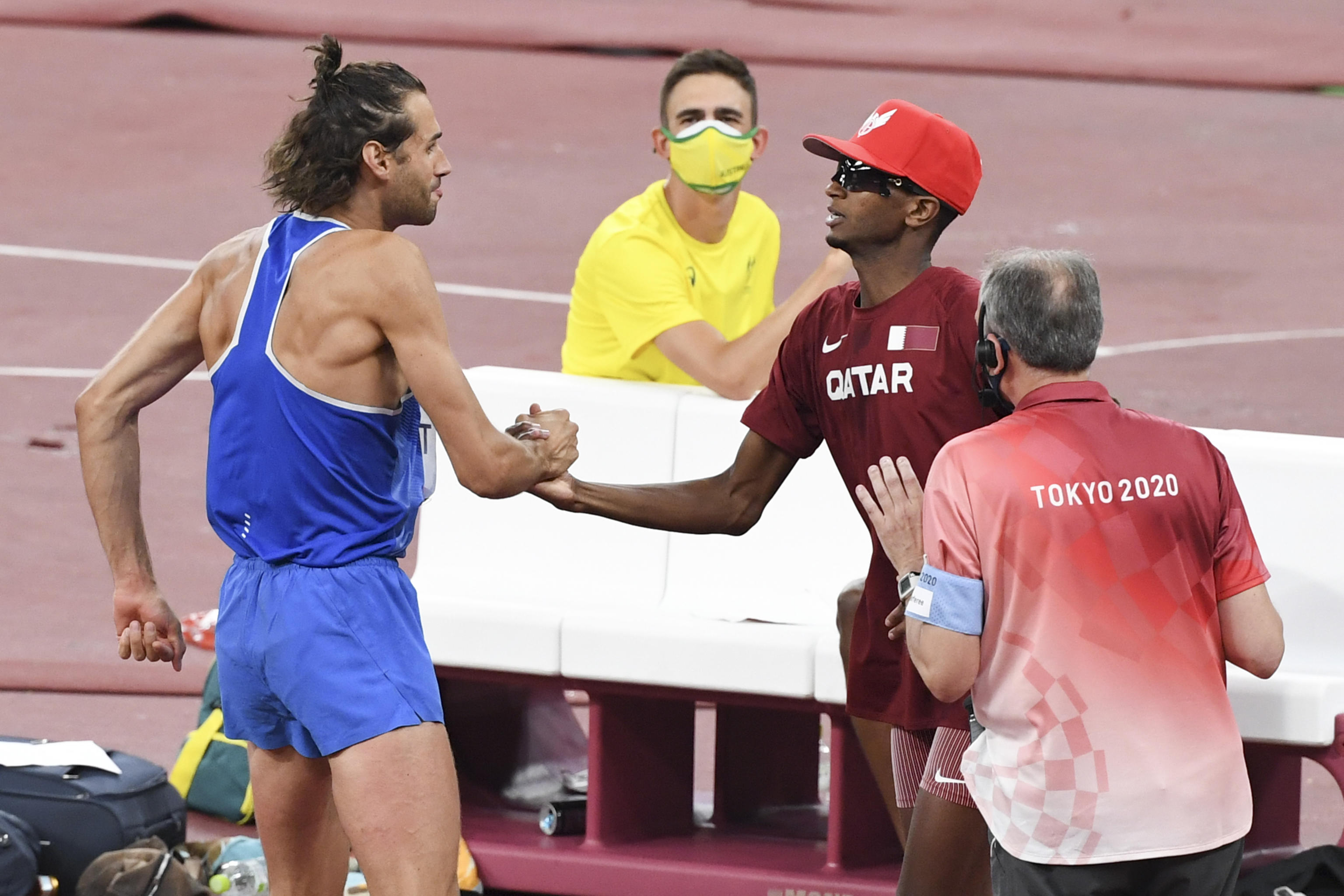 Gianmarco Tamberi of Italy (L) and Mutaz Essa Barshim of Qatar (R) celebrate as they share the first place and gold medal in the Men's High Jump Final during the Athletics events of the Tokyo 2020 Olympic Games at the Olympic Stadium in Tokyo, Japan, 01 August 2021.   ANSA / CIRO FUSCO