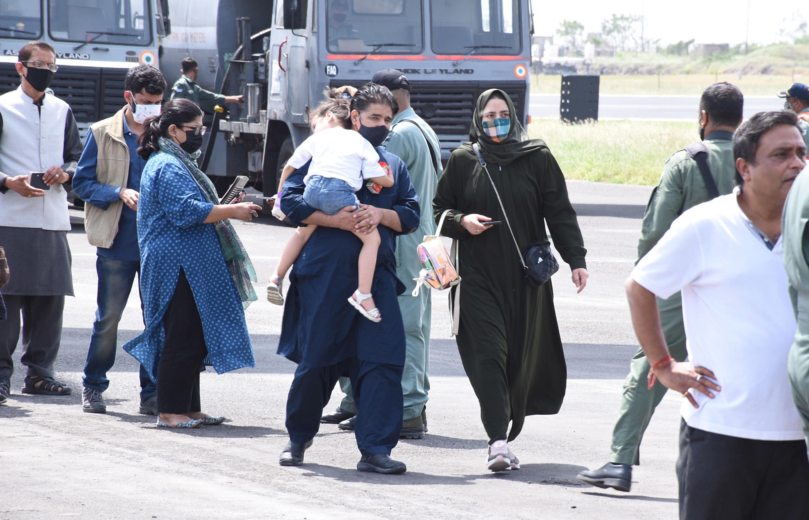epa09418681 A handout photo made available by the District Information Office Jamnagar, Gujarat, on 18 August 2021 shows people airlifted from Kabul, Afghanistan, after Taliban took over the government, arriving at Jamnagar airbase, Gujarat, India, 17 August 2021. Indian Air force aircraft C-17 Globemaster landed with over 120 Indian diplomats and officials from Kabul.  EPA/DISTRICT  INFORMATION OFFICE JAMNAGAR HANDOUT  HANDOUT EDITORIAL USE ONLY/NO SALES
