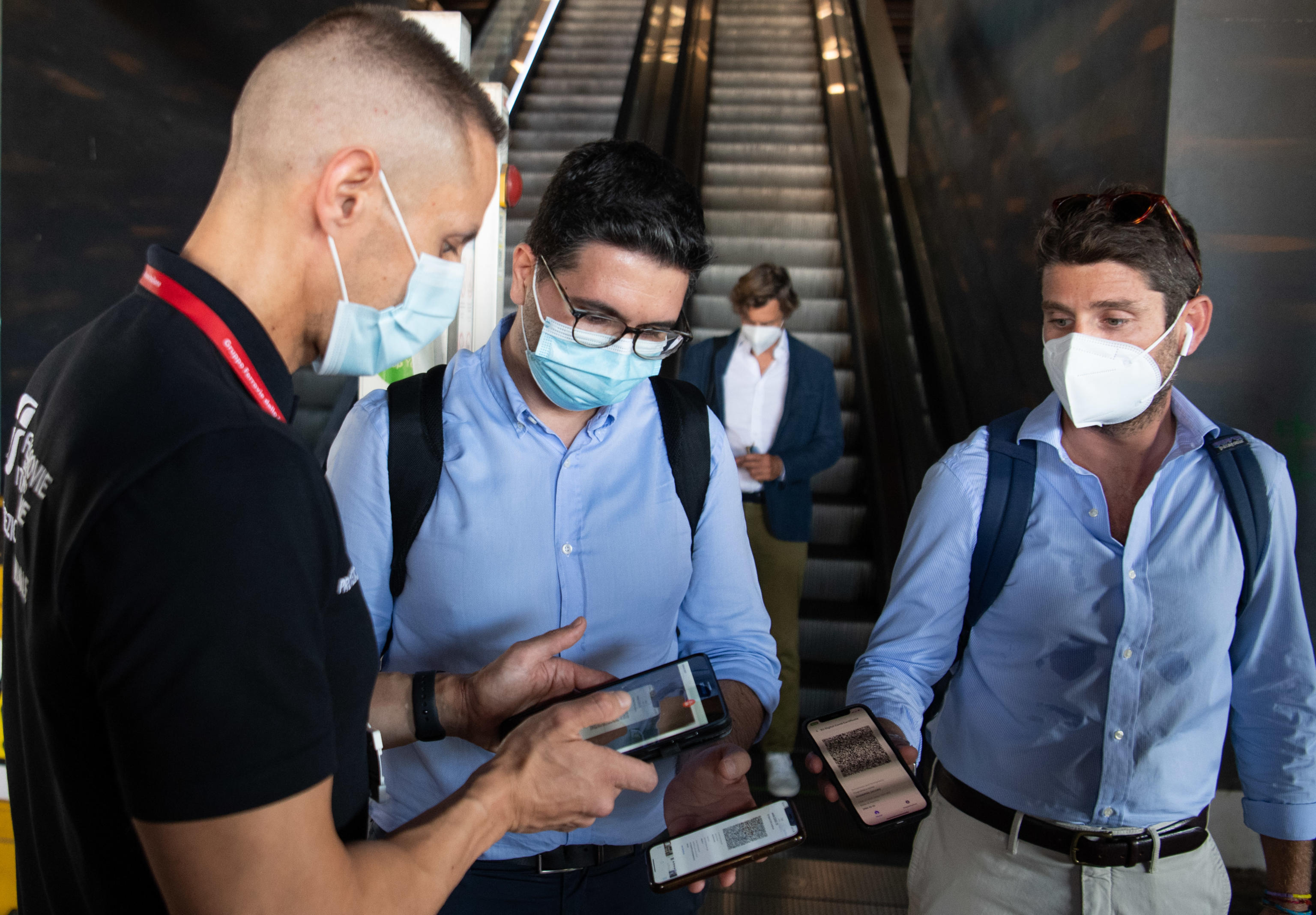 Passegngers show their Green Pass ahead their departure at theTiburtina station, Rome, Italy, 1 September 2021. . The Italian government's COVID-19 Green Pass vaccine passport became compulsory for travel on long-distance trains, buses and domestic airplanes on 01 September, amid an alert for announced protests by anti-vaxxers. Police heightened security at train stations overnight against the anti-vaxxers, who have threatened to block trains on 01 September afternoon.  MAURIZIO BRAMBATTI/ANSA