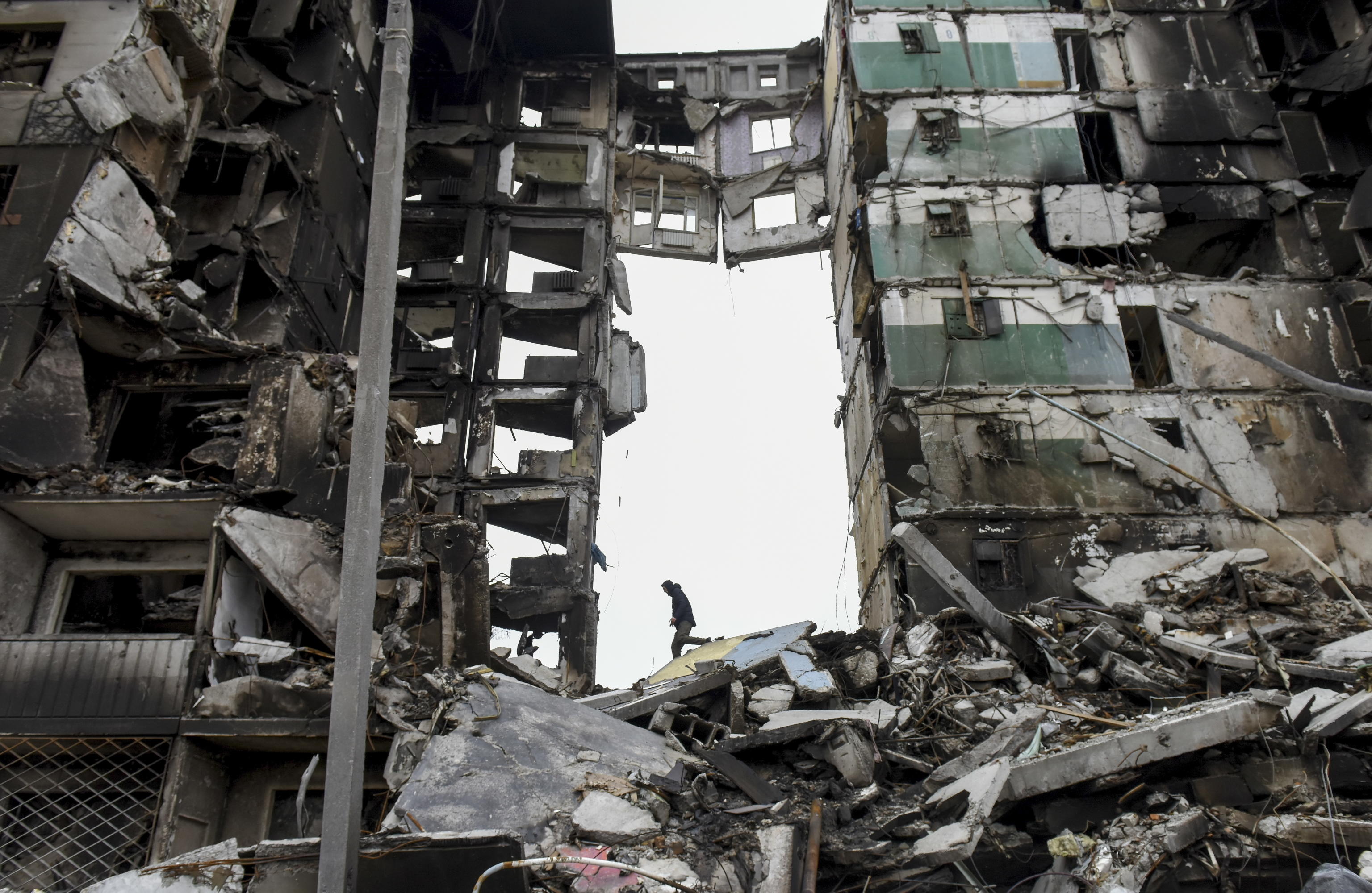 epa09872658 A man climbs on the destroyed apartment block in the city of Borodyanka near Kyiv (Kiev), Ukraine, 05 April 2022. On 24 February, Russian troops had entered Ukrainian territory in what the Russian president declared a 'special military operation', resulting in fighting and destruction in the country, a huge flow of refugees, and multiple sanctions against Russia.  EPA/OLEG PETRASYUK