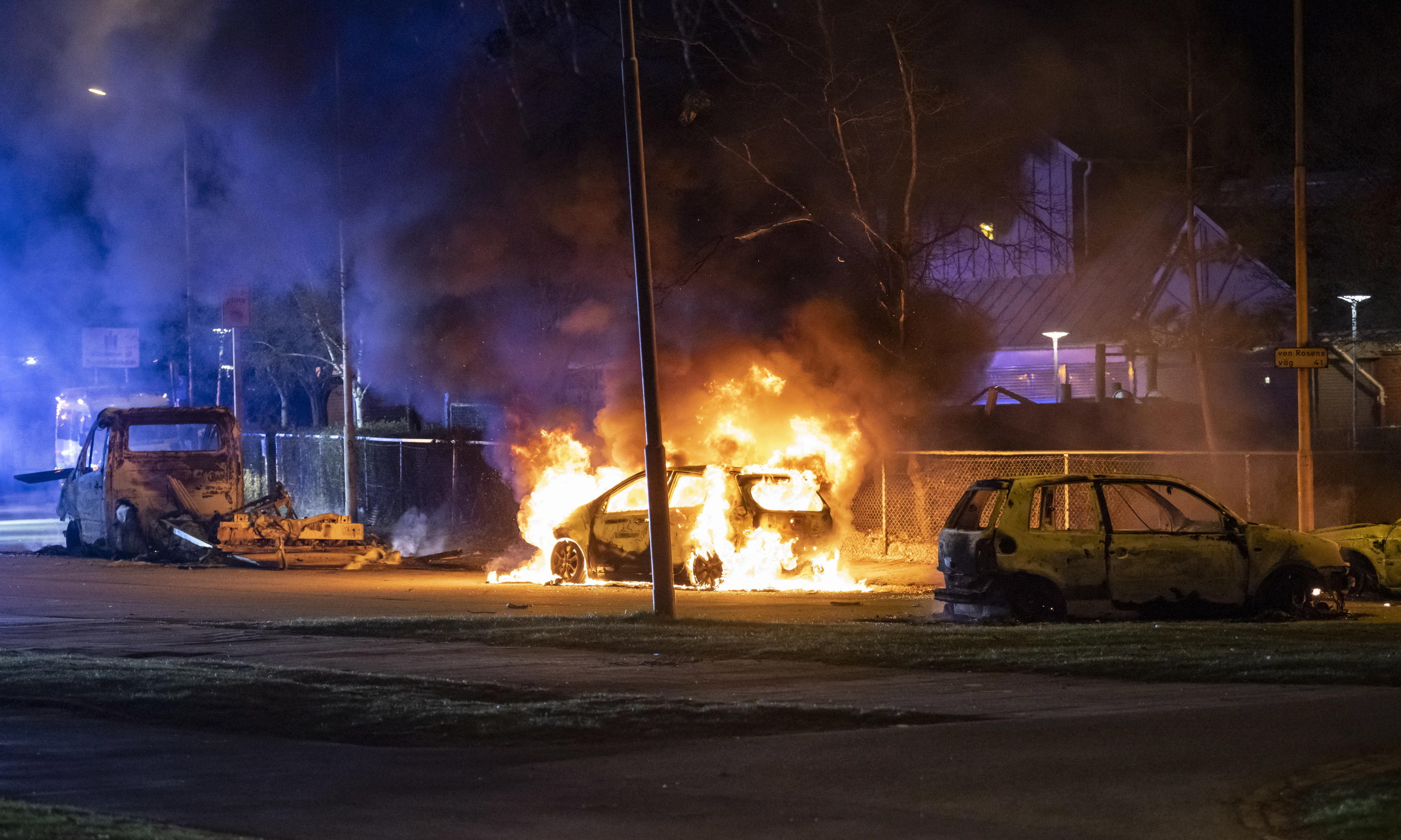 epa09895564 Cars burn during a protest at Rosengard in Malmo, Sweden, late 17 April 2022 (issued 18 April 2022). The police went to the scene with a large number of vehicles and fired tear gas to disperse crowd. Violent unrest continue in Malmo following statements by the leader of the far-right political party Hard Line, Danish-Swedish politician Rasmus Paludan, who had already sparked outrage after burning a copy of the Koran on 14 April in a heavily-populated Muslim area in the town of Linkoping.  EPA/JOHAN NILSSON  SWEDEN OUT