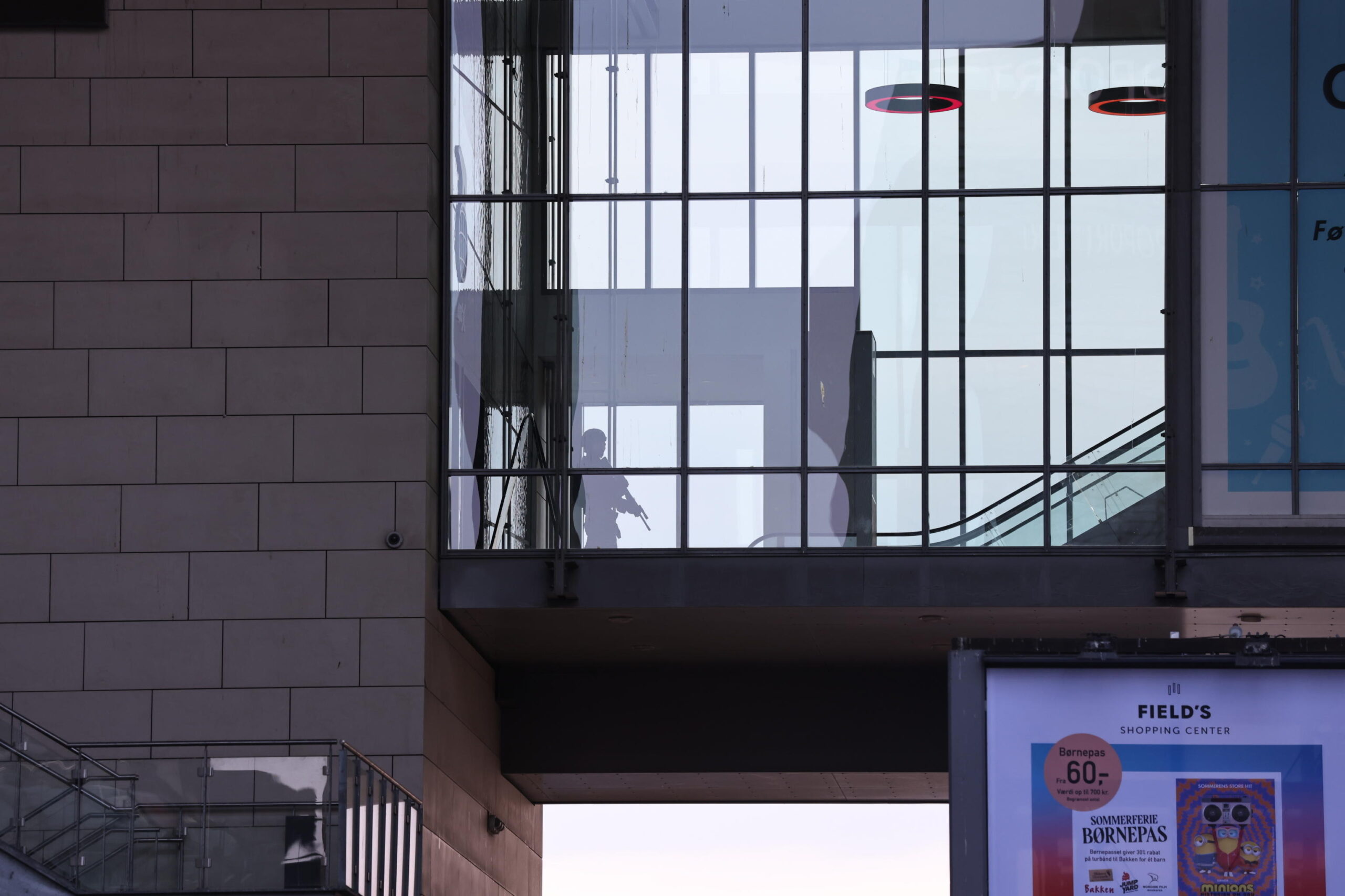 epa10049998 Armed police seen inside of the Fields shopping center during evacuation in Oerstad, Copenhagen, Denmark, 03 July 2022. According to Danish News Agency Ritzau, people reported shots fired in the Fields shopping center in Copenhagen.  EPA/Olafur Steinar Gestsson  DENMARK OUT
