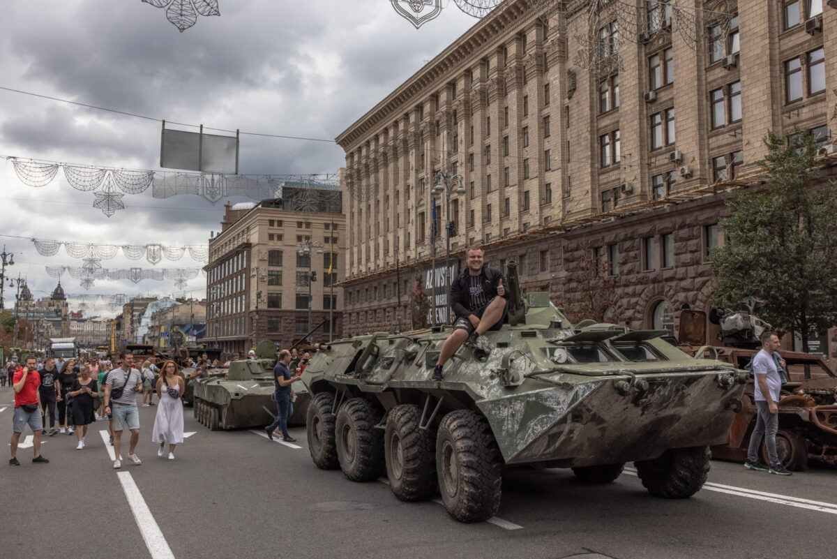 epa10130456 A man poses for photos on a Russian armoured personnel carrier that was damaged in fights with the Ukrainian army, displayed on Khreshchatyk street, in downtown Kyiv, ahead of the 'Independence Day', Ukraine, 20 August 2022. Ukrainians will mark the 31st anniversary of Ukraine's independence from the Soviet Union in 1991, as the Russian invasion continues. Russian troops on 24 February entered Ukrainian territory, starting the conflict that has provoked destruction and a humanitarian crisis.  EPA/ROMAN PILIPEY