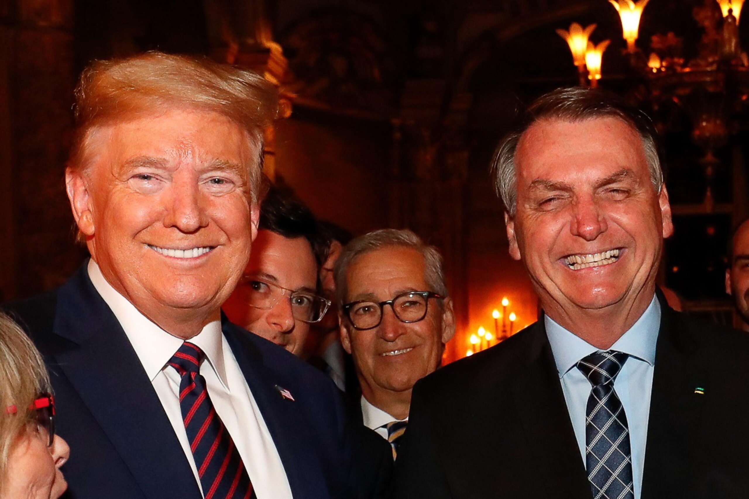 epa08290203 Handout picture provided by the Brazilian Presidency showing President Jair Bolsonaro (R), along with his Press Secretary, Fabio Wajngarten (2-L, partially obscured), during a meeting with US President Donald Trump (L), at the Mar-a-Lago residence in Palm Beach, USA, 07 March 2020 (issued 12 March 2020). US President Donald Trump said Thursday that he is not 'concerned' about the possibility of contracting the coronavirus after the Brazilian government's press chief, Fabio Wajngarten was diagnosed with the disease, with whom he met and posed for a photo on 07 March.  EPA/Alan Santos/Brazilian Presidency HANDOUT /EDITORIAL USE ONLY/ NO SALES HANDOUT EDITORIAL USE ONLY/NO SALES