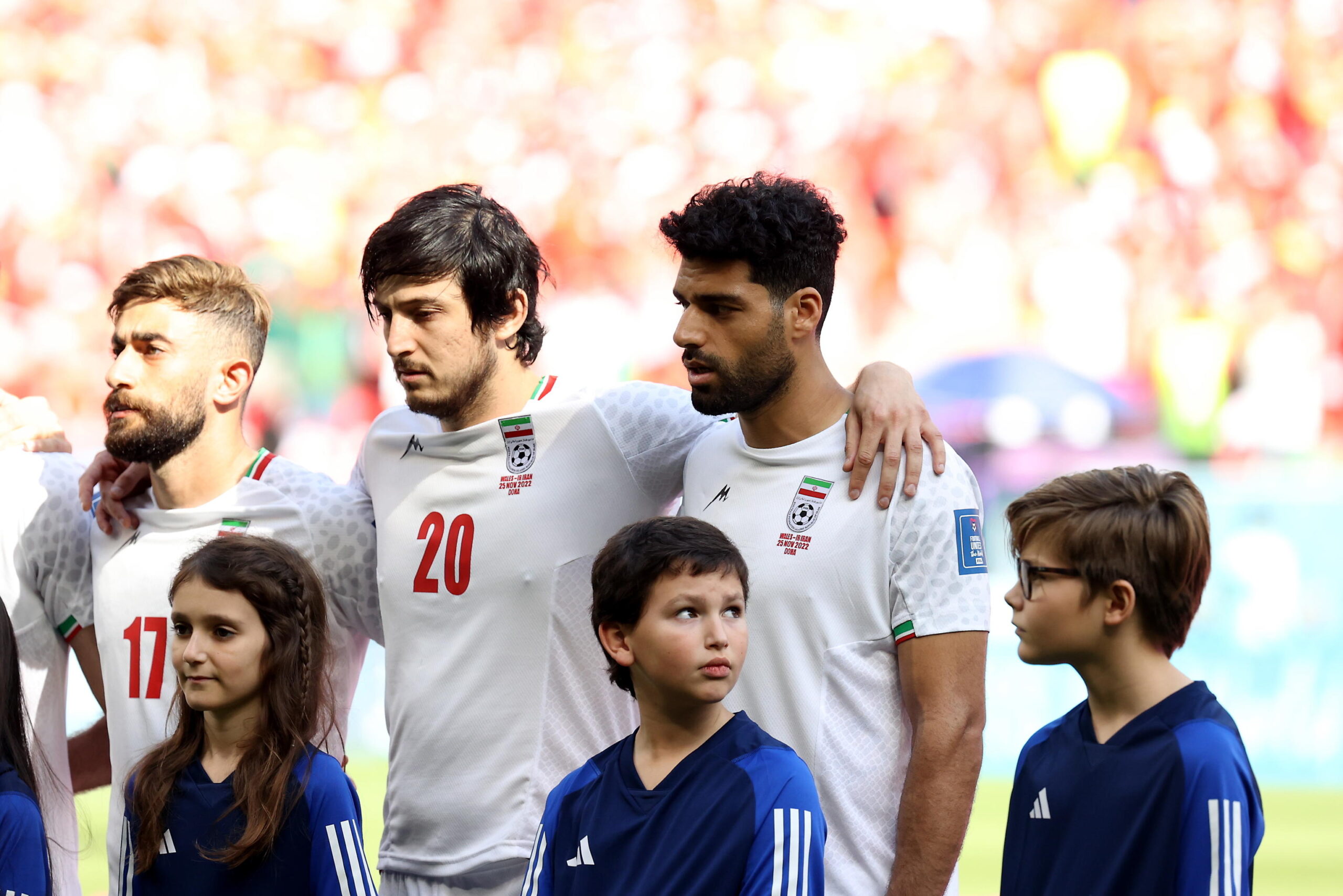 epa10326893 Mehdi Taremi (R) and players of Iran during the national anthem prior the FIFA World Cup 2022 group B soccer match between Wales and Iran at Ahmad bin Ali Stadium in Doha, Qatar, 25 November 2022.  EPA/Abedin Taherkenareh
