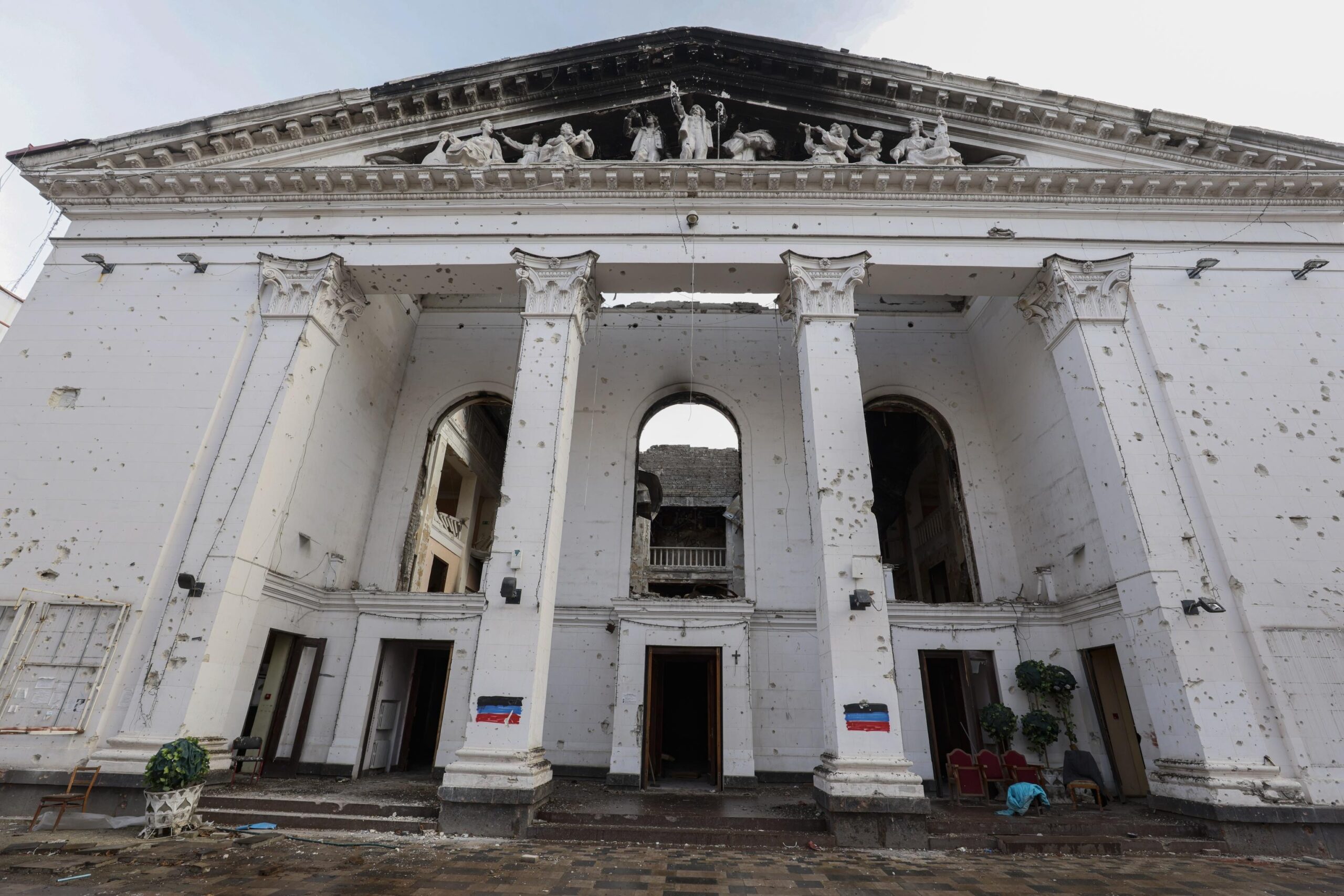 epa10355689 Exterior view of the destroyed Drama Theatre in Mariupol, Ukraine, 08 December 2022. The Mariupol Drama Theater was destroyed on 16 March during Russian airstrikes and the siege of the city. The restoration of the theater by Russian specialists began in September and is scheduled to finished within three years. More than 5,000 builders are currently working on the restoration of the city, the number of personne is to be increased to 30,000 by spring 2023. Mariupol is expected to be completely rebuilt in three years.  EPA/SERGEI ILNITSKY