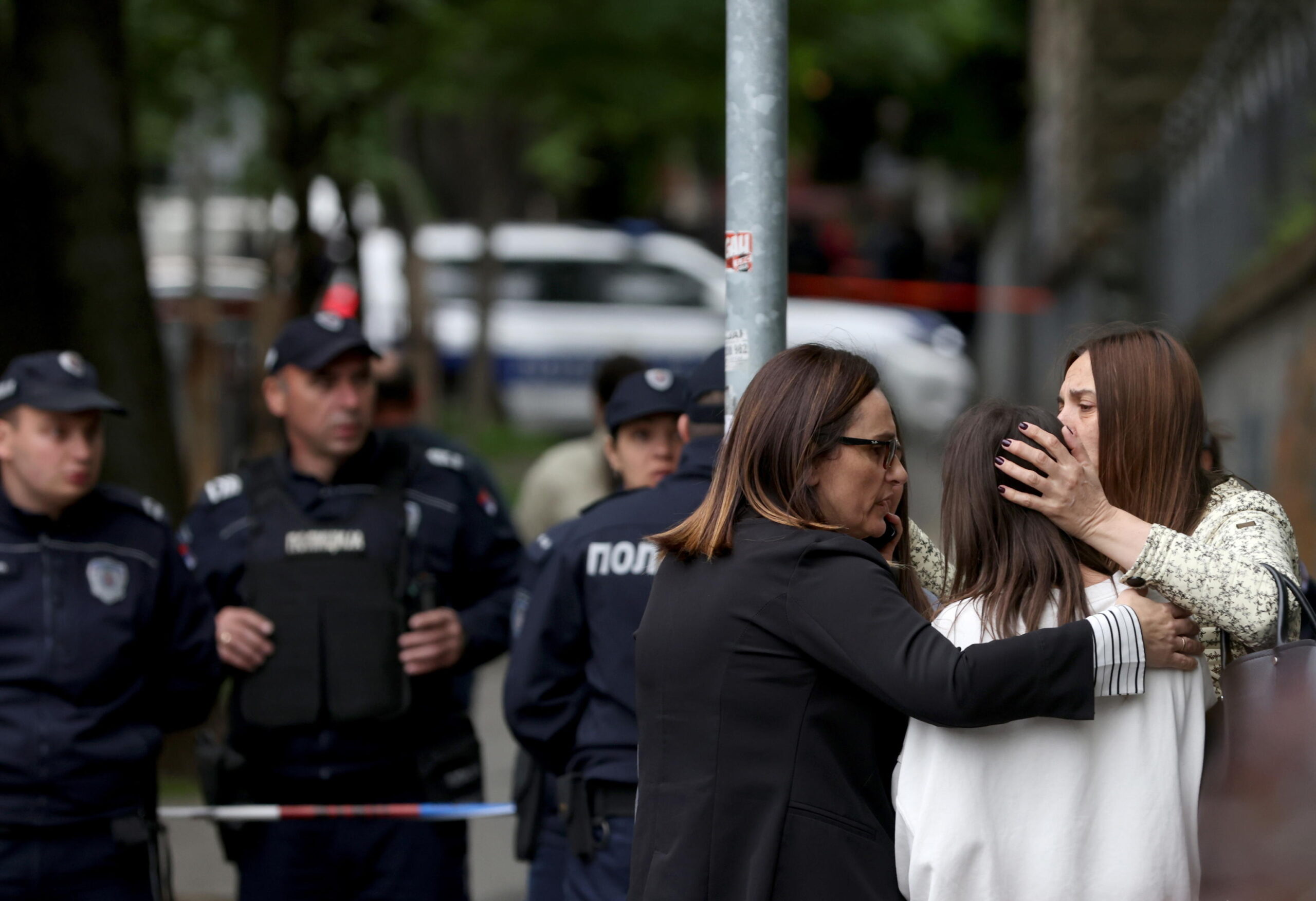 epa10605740 Teachers console students near the Vladislav Ribnikar elementary school in Belgrade, Serbia, 03 May 2023. A teenage suspect opened fire causing one fatality and multiple injuries according to Serbia's Interior ministry.  EPA/ANDREJ CUKIC