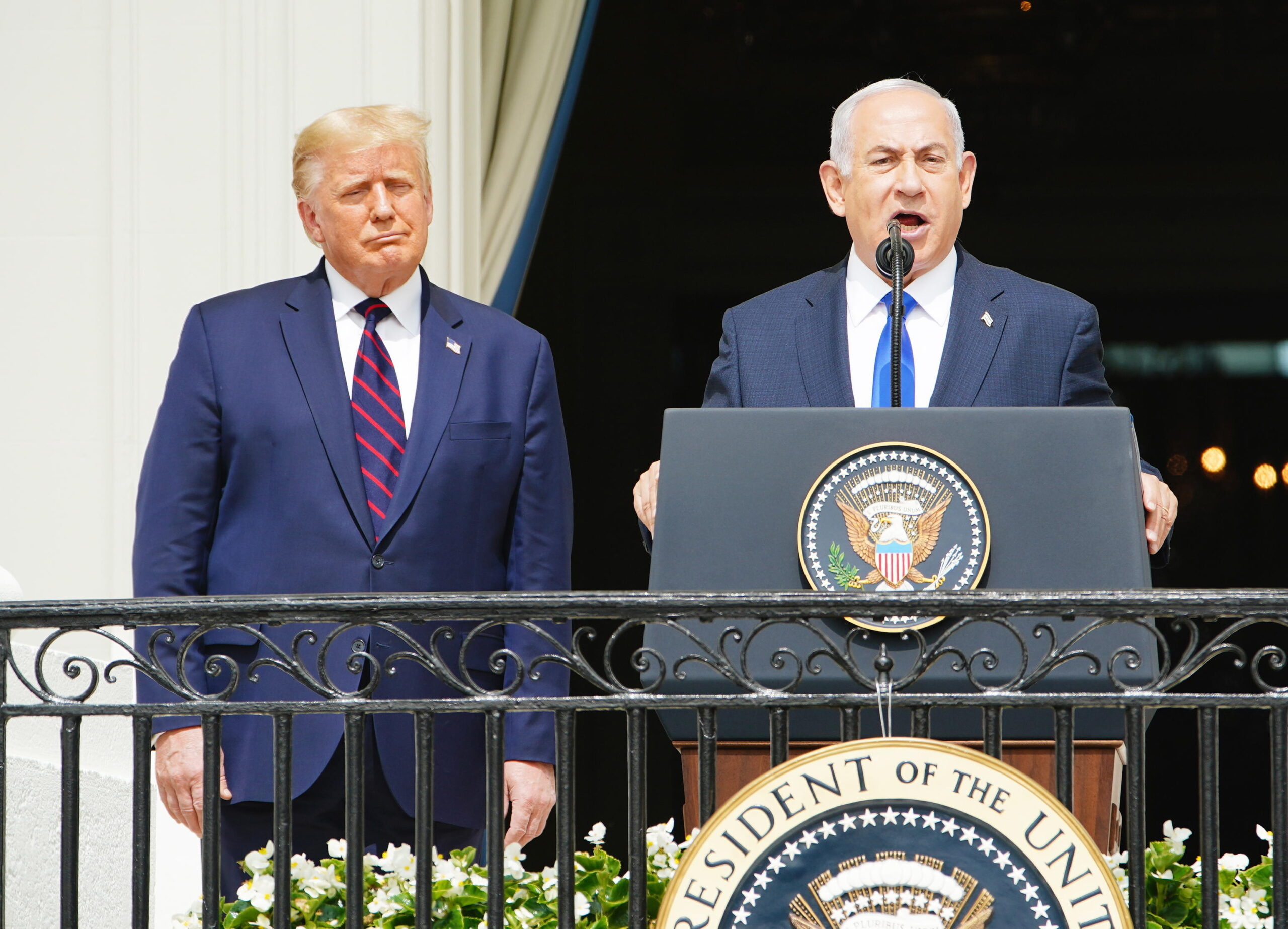 epa08671174 Israeli Prime Minister Benjamin Netanyahu (R) speaks as US President Donald J. Trump (L) listens during the Abraham Accords signing ceremony, which normalizes relations between the United Arab Emirates and Bahrain with Israel, on the South Lawn of the White House in Washington, DC, USA, 15 September 2020.  EPA/JIM LO SCALZO
