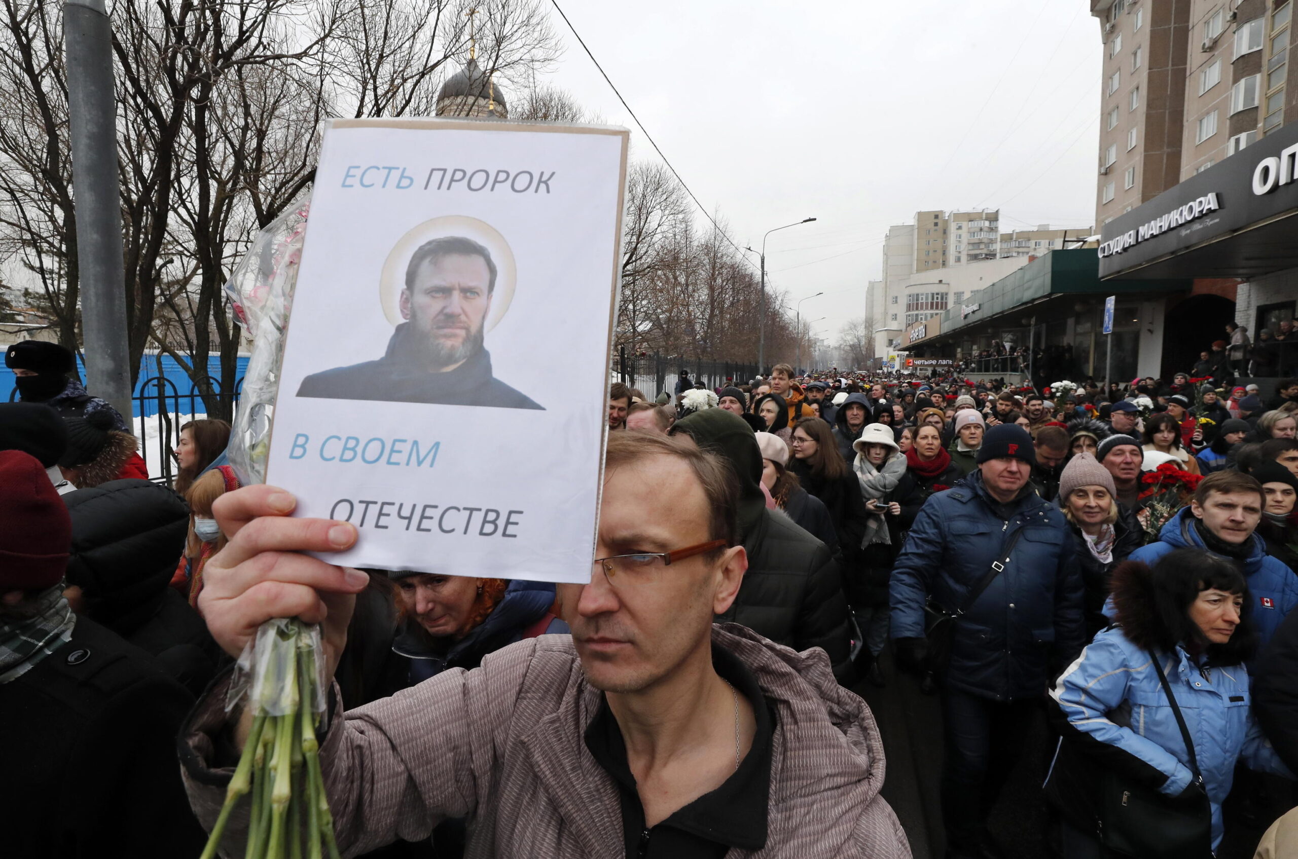 epa11190935 Russian people follow the hearse with the coffin of late Russian opposition leader Alexei Navalny outside the Church of the Icon of the Mother of God during his funeral in Moscow, Russia, 01 March 2024. Outspoken Kremlin critic Navalny died aged 47 in an arctic penal colony on 16 February 2024 after being transferred there in 2023. The colony is considered to be one of the worlds harshest prisons. The poster with the image of Alexei Navalny reads: There is a Prophet in His Homeland.  EPA/MAXIM SHIPENKOV