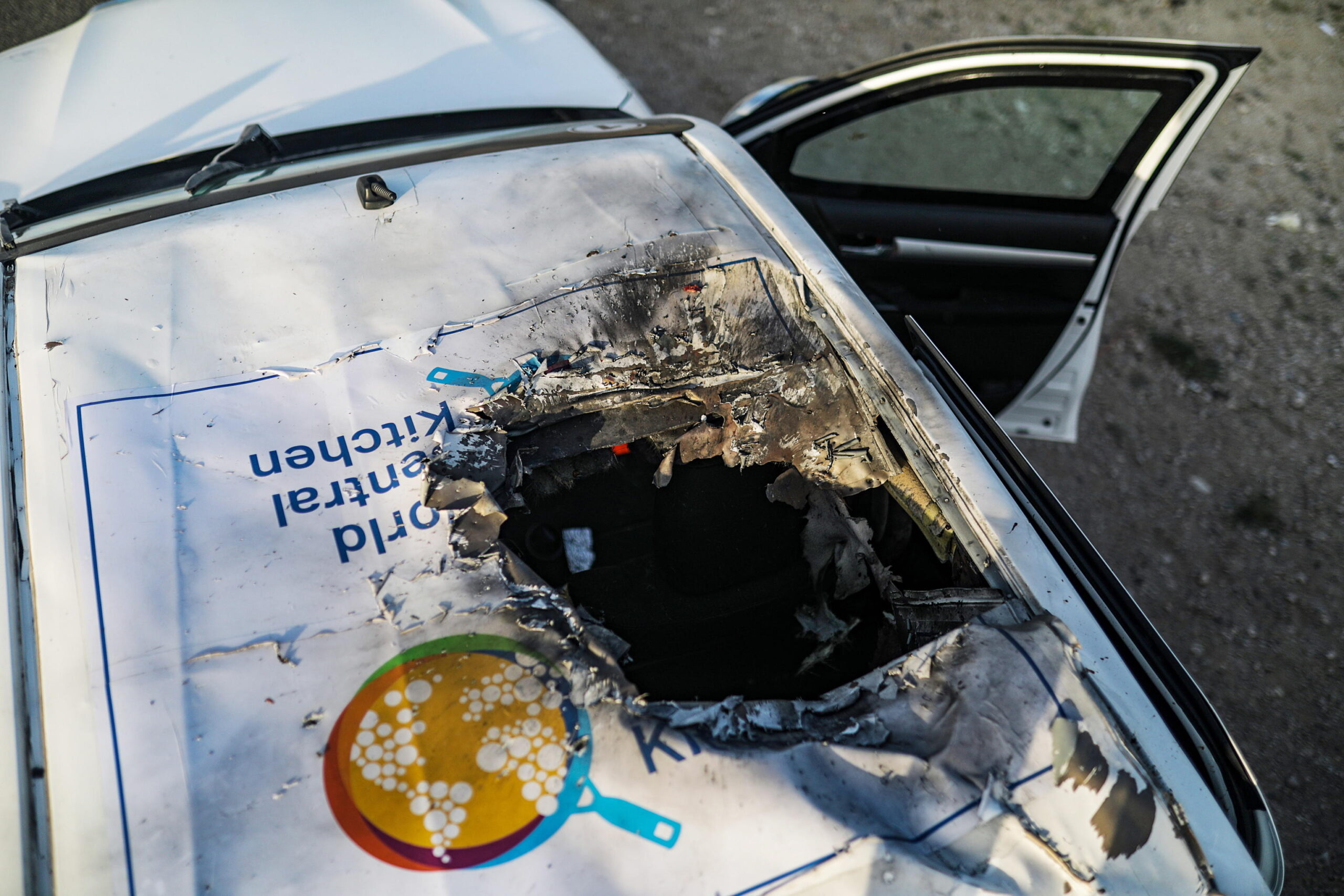epa11255114 A destroyed car of the NGO World Central Kitchen (WCK) sits along Al Rashid road, between Deir Al Balah and Khan Younis in the southern Gaza Strip, 02 April 2024. According to the Palestinian Red Crescent, at least four people from the NGO World Central Kitchen (WCK) were killed when a missile hit their convoy in Deir al Balah while they were on their way from Rafah to Gaza City to receive fresh aid delivered by the Open Arms vessel. The victims were confirmed to be a British, a Polish and an Australian citizen, while the nationality of the fourth victim was still unknown.  EPA/MOHAMMED SABER