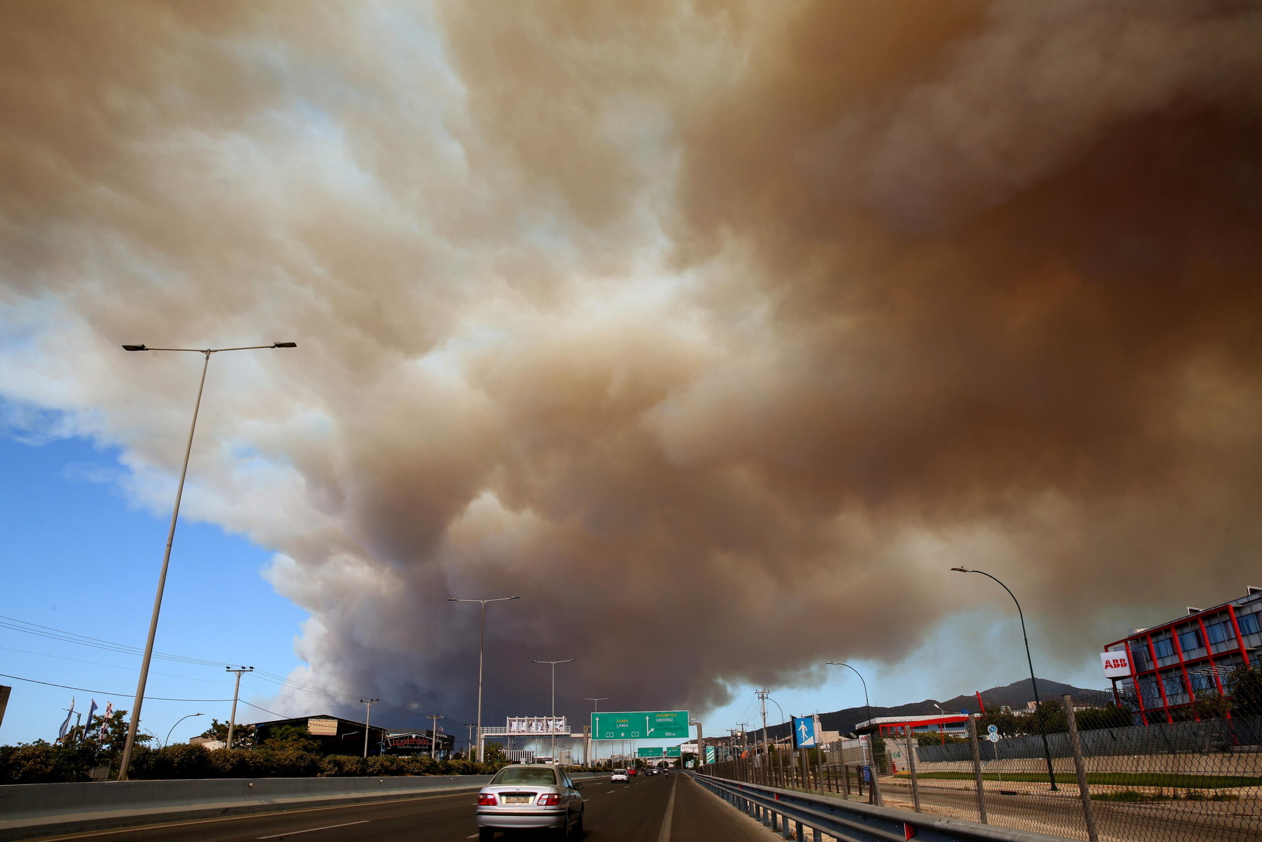 Thick smoke covers the National Highway in Athens from a wildfire that broke out in a farmland and forest area in Varnavas, Attica region, Greece, 11 August 2024. The fire brigade has deployed 165 firefighters, nine teams on foot, 30 vehicles, seven firefighting aircraft, and five helicopters to extinguish the flames. Varnavas residents have been instructed to evacuate the area via a message from the 112 emergency number. EPA/ALEXANDROS BELTES