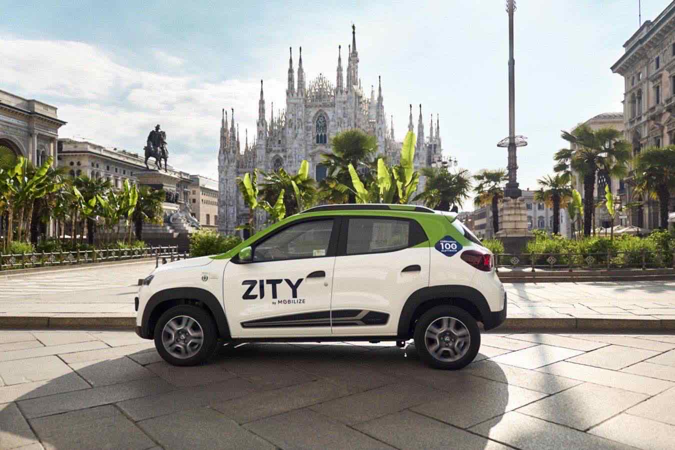 Un’auto elettrica parcheggiata in una zona periferica di Milano, con segnali di informazione sul car sharing